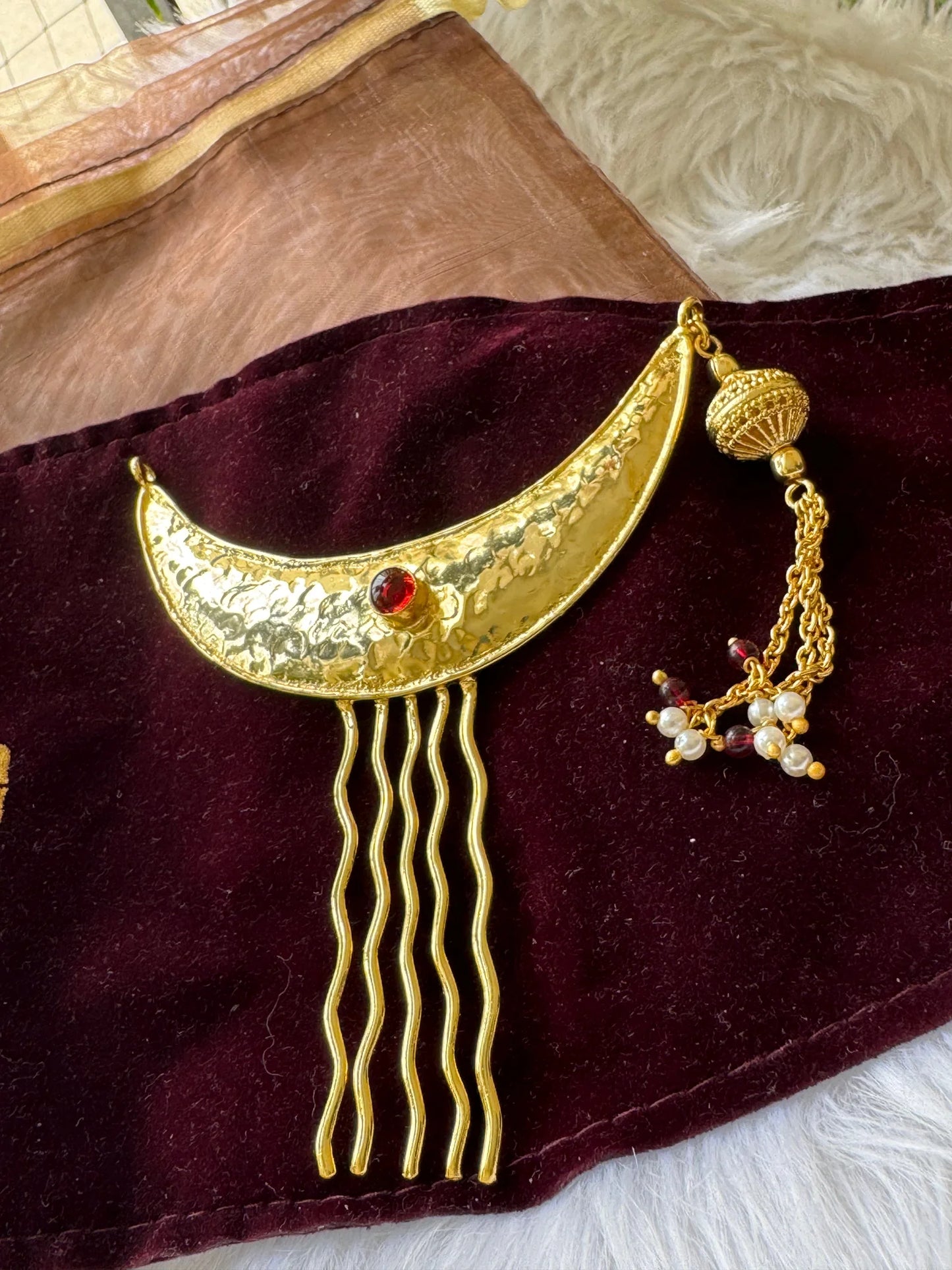 Golden Moon hair pin with hammered gold crescent, red stone, and dangling pearl charm on burgundy velvet by Bows and Bags