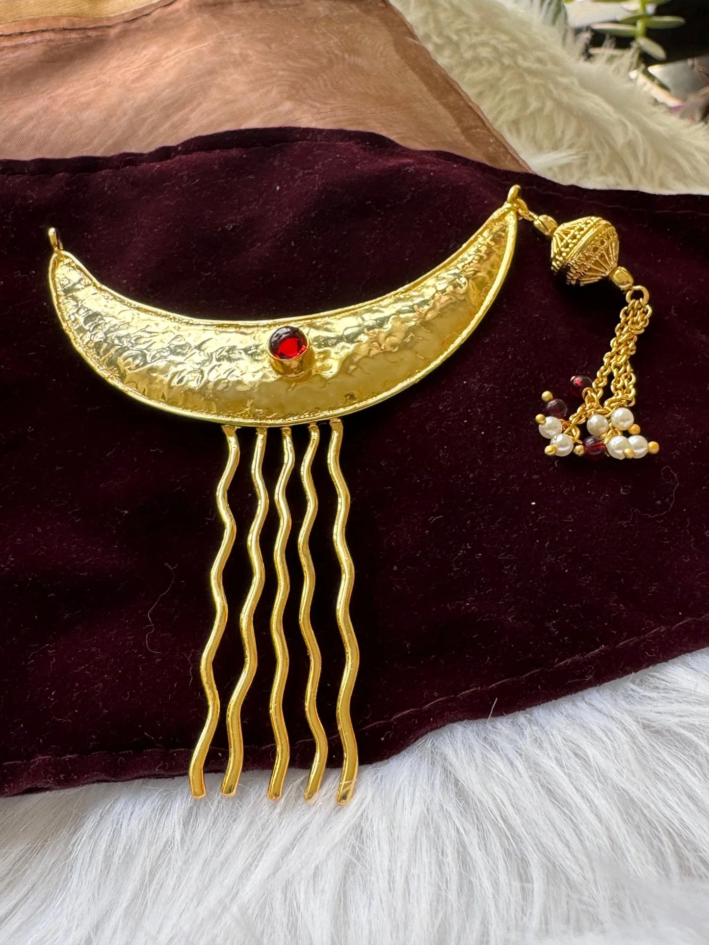 Golden Moon hair pin with hammered gold crescent, red stone, and pearl charm displayed on velvet by Bows and Bags India