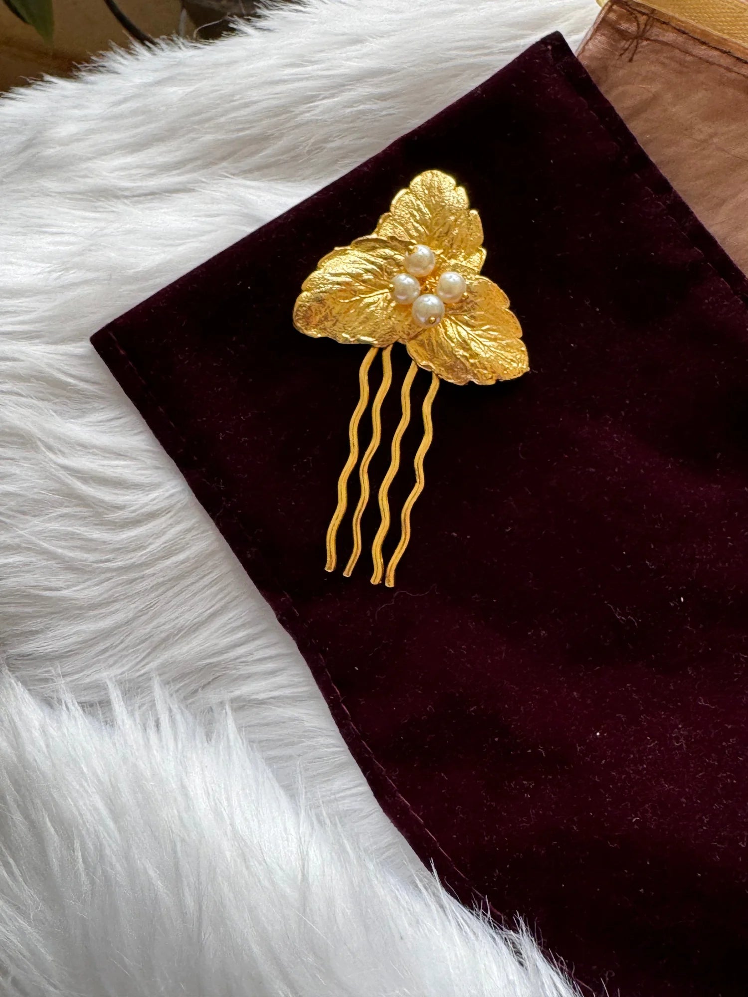 Golden Pearls Leaf hair pin with textured gold leaves and pearl cluster on burgundy velvet by Bows and Bags India