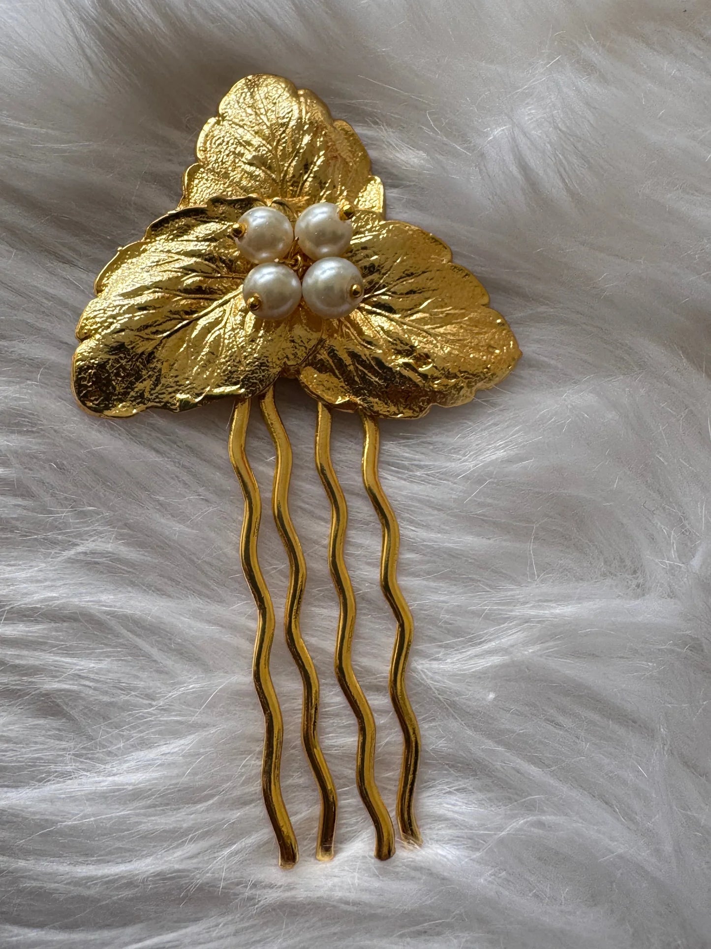 Golden textured leaf hair pin with pearl cluster by Bows and Bags India, handmade metal accessory on white background