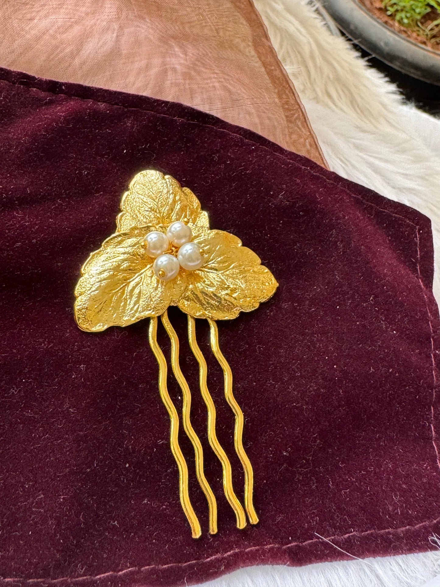 Golden Pearls Leaf hair pin with textured gold leaves and pearl cluster on burgundy velvet by Bows and Bags India