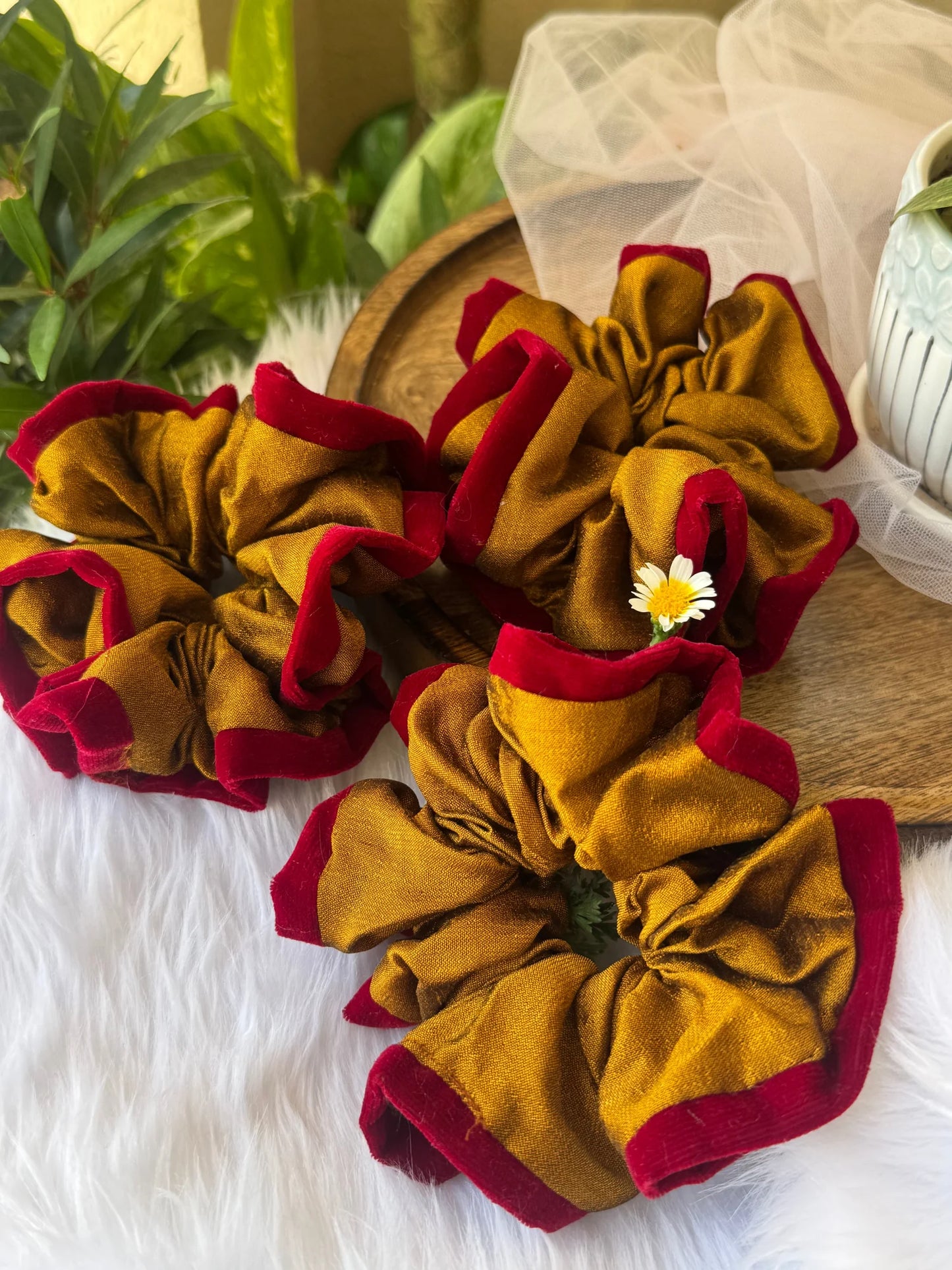 Golden Sunset handmade silk scrunchie with maroon velvet in lifestyle display by Bows and Bags India