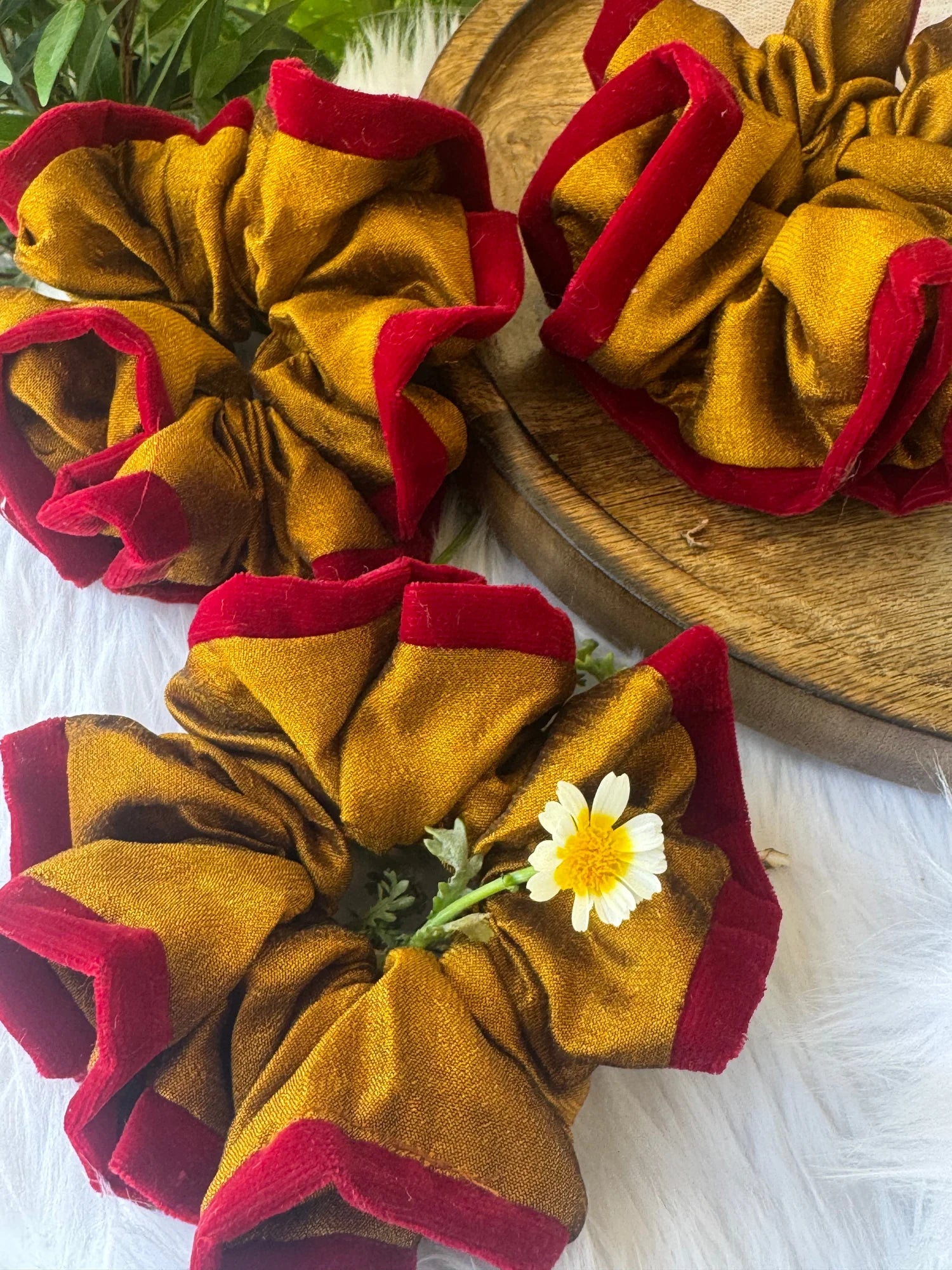 Golden yellow silk scrunchies with maroon velvet lining by Bows and Bags India, handmade hair accessories displayed on