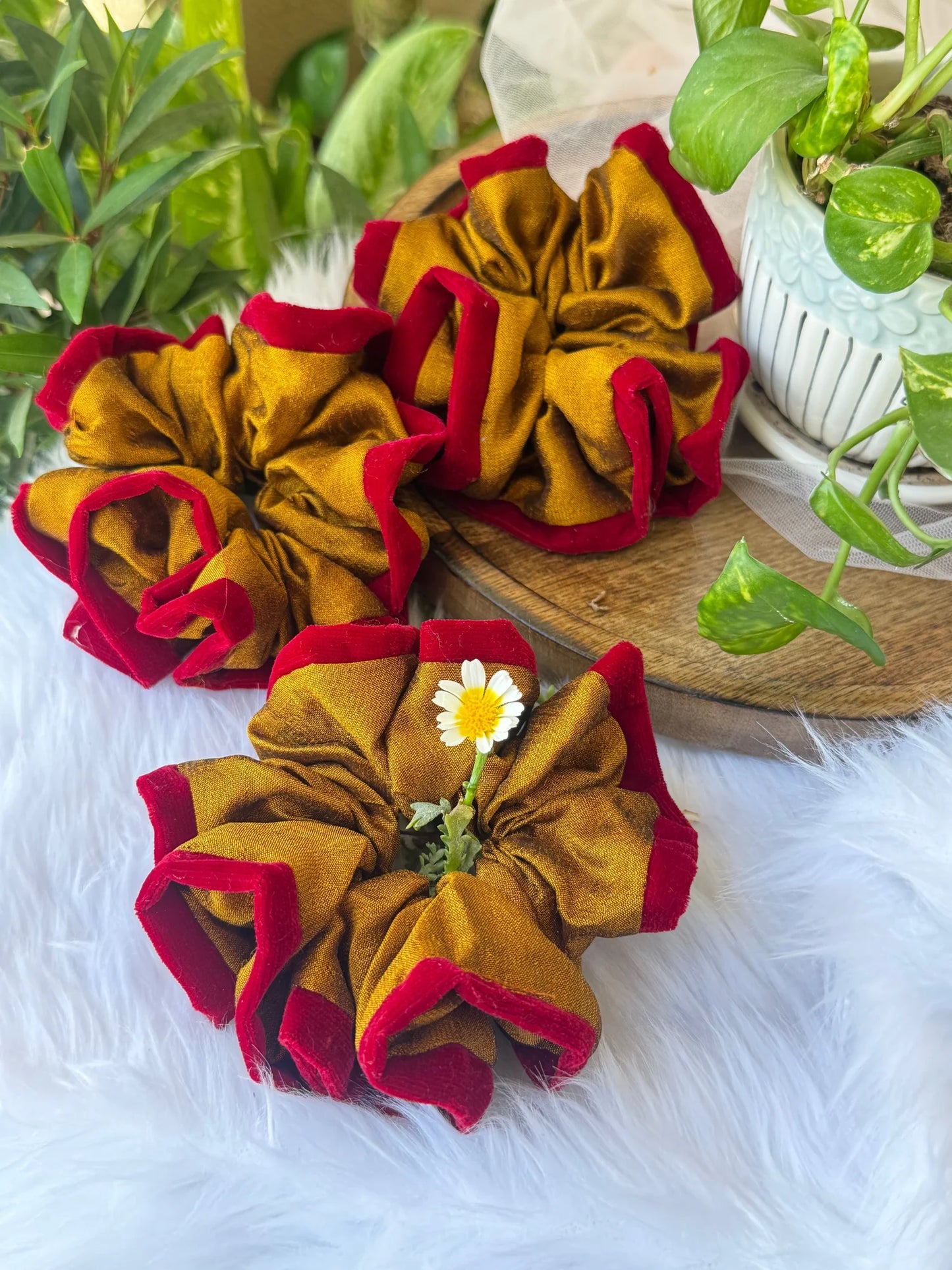 Golden yellow silk scrunchie with maroon velvet edging by Bows and Bags India, handmade hair accessory displayed on wooden