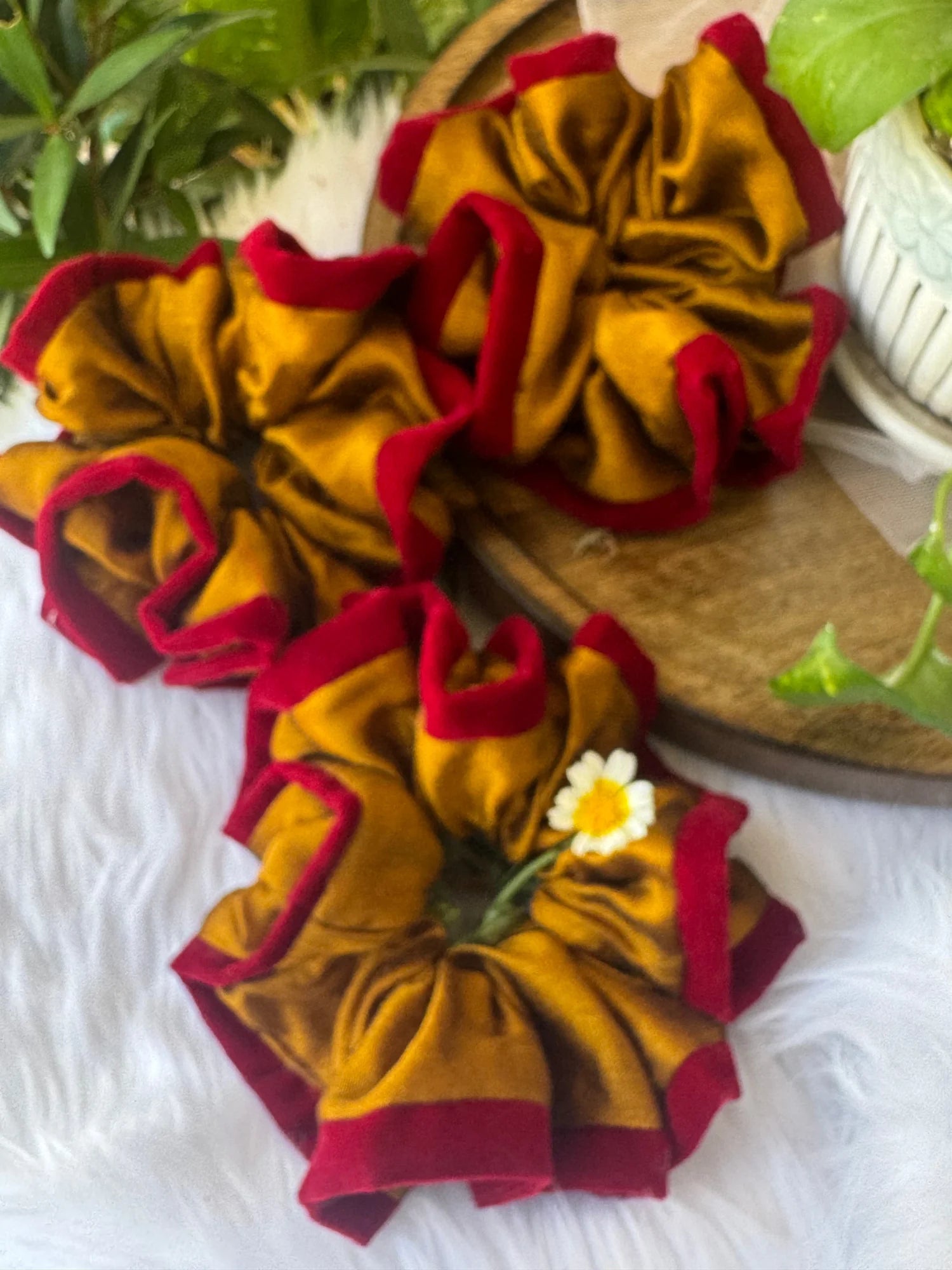 Golden yellow silk scrunchie with maroon velvet trim by Bows and Bags India, handmade hair accessory displayed on white
