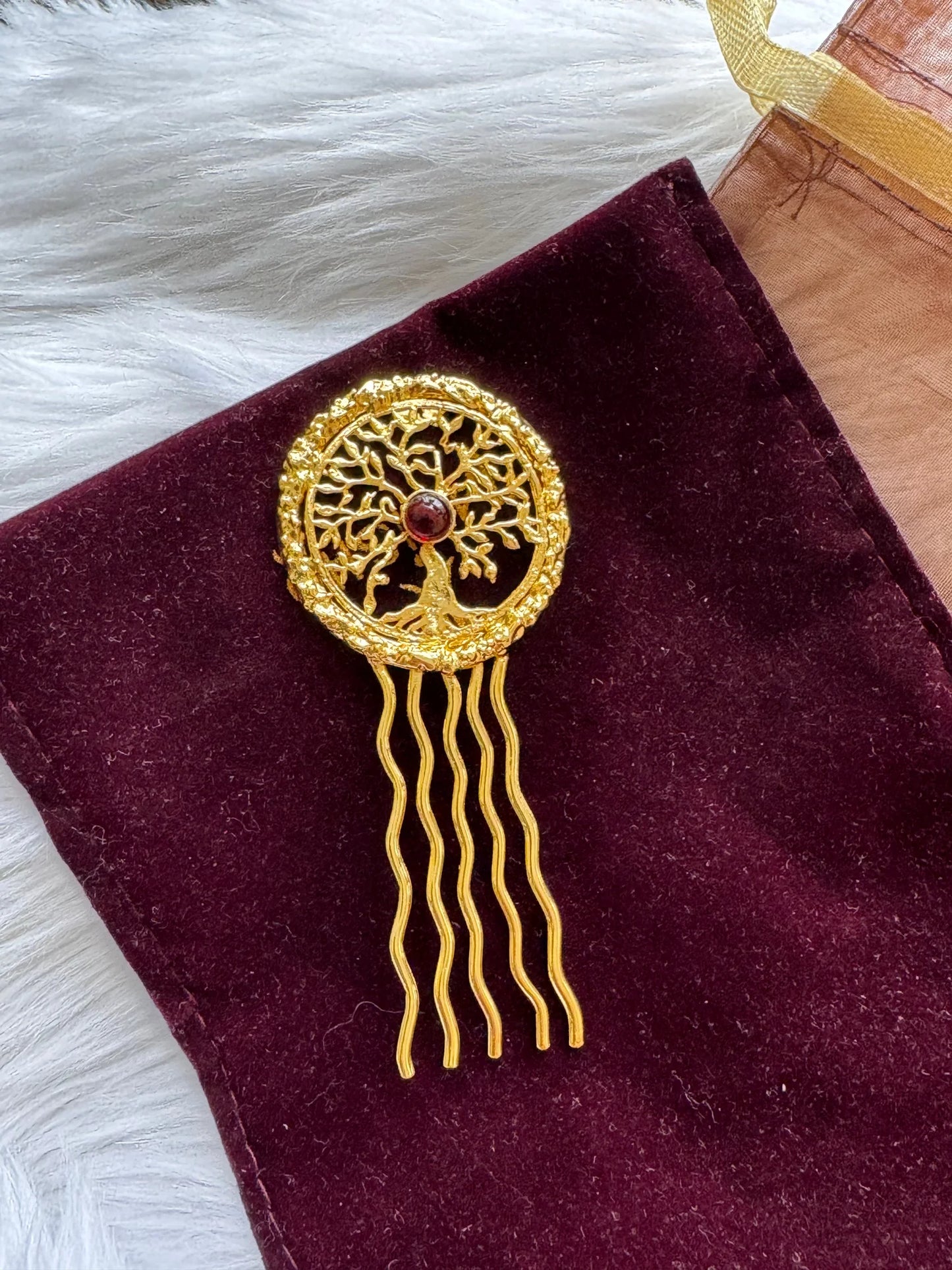 Golden Tree hair pin with intricate tree of life design, red stone center, gold metal prongs on burgundy velvet by Bows and