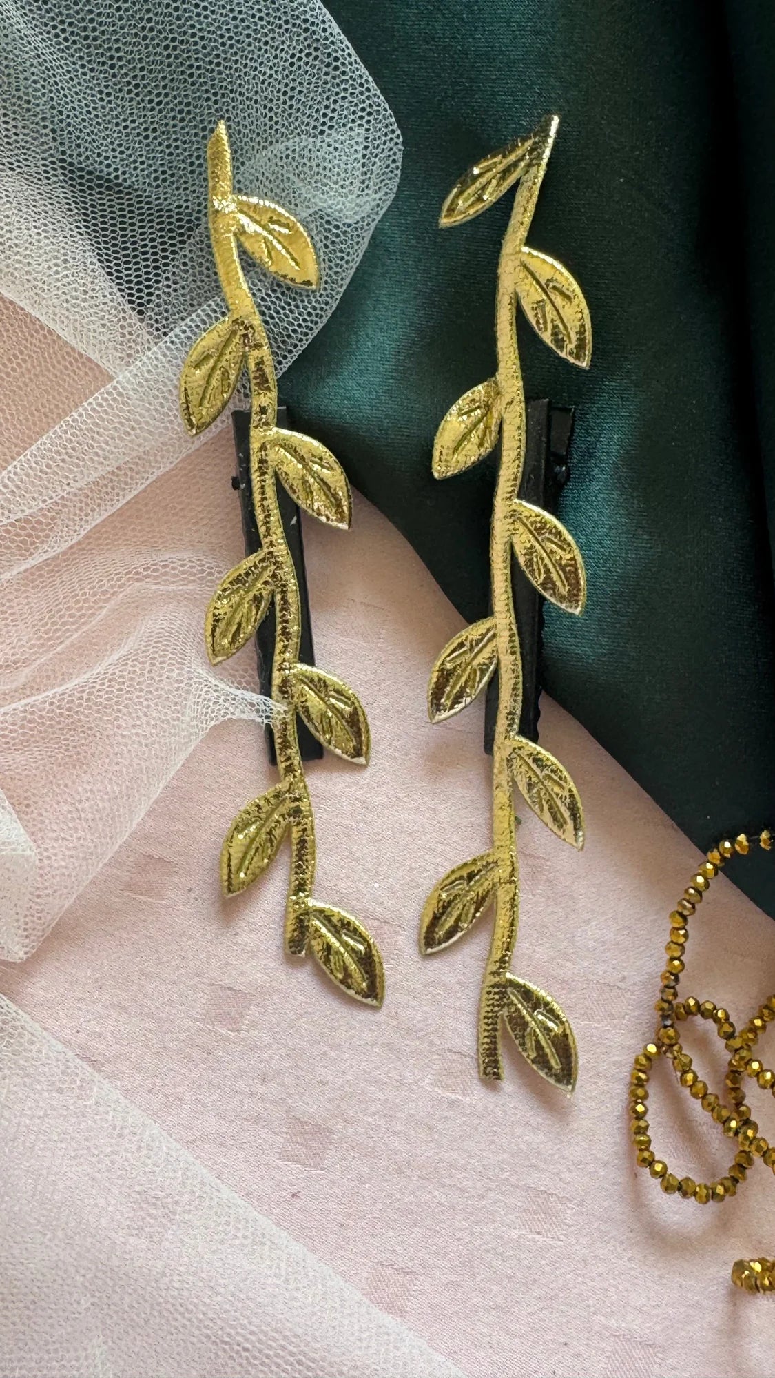 Golden Twig hair clip pair displayed on blush tulle, handmade gold leaf design by Bows and Bags India