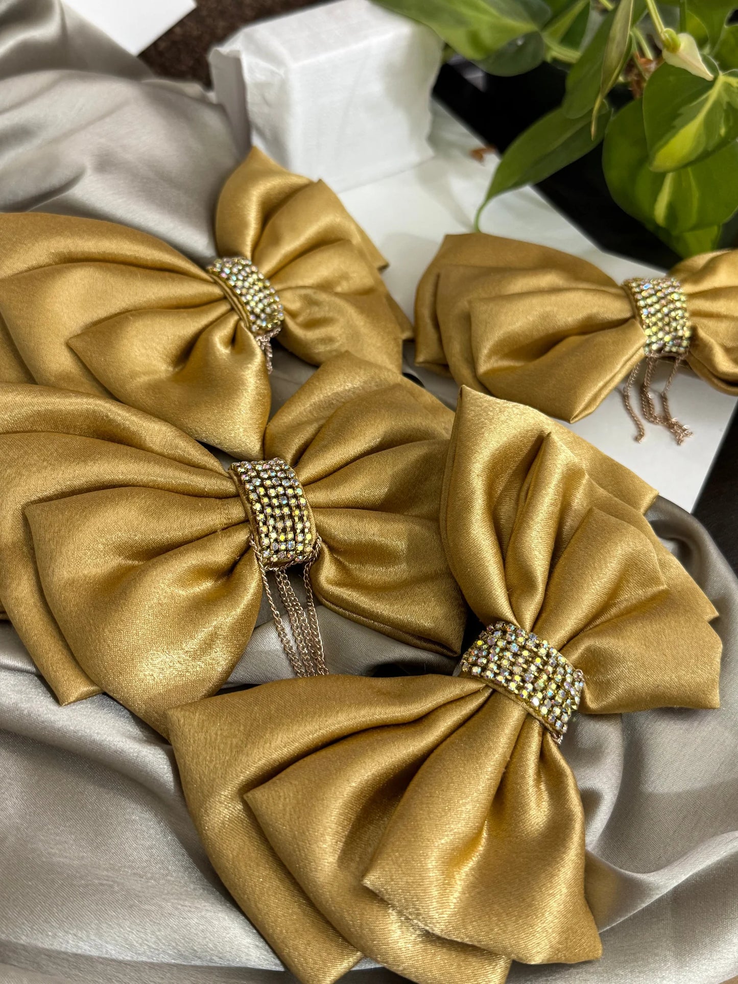 Goldy Bling stone studded golden hair bow with rhinestone chain detail displayed flat lay, handmade by Bows and Bags India