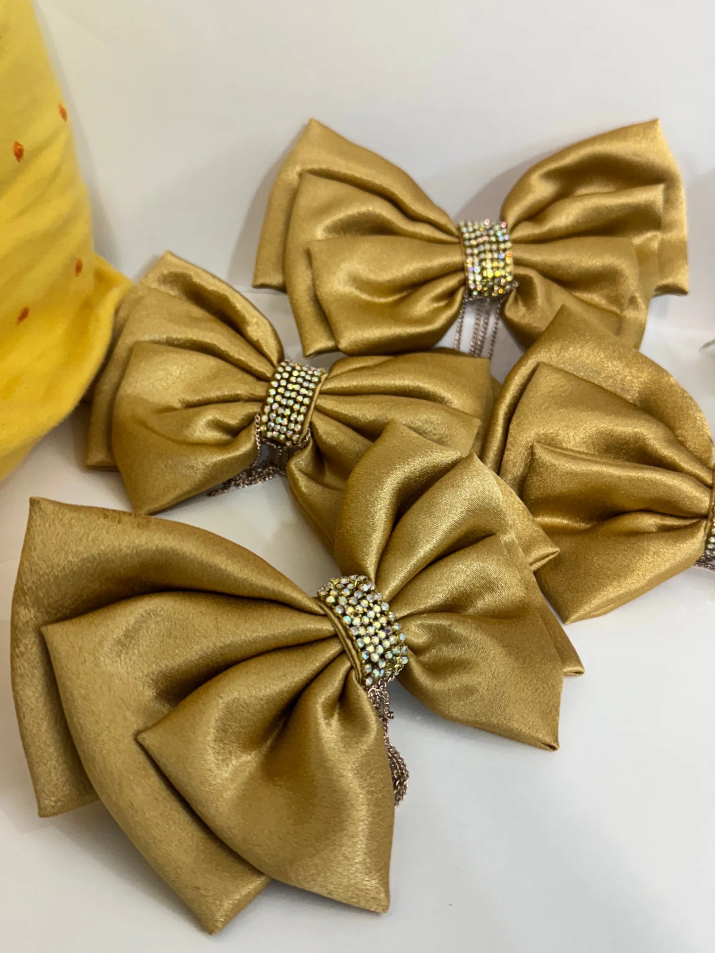 Golden stone studded hair bows from Bows and Bags India displaying luxurious satin texture and rhinestone embellishments