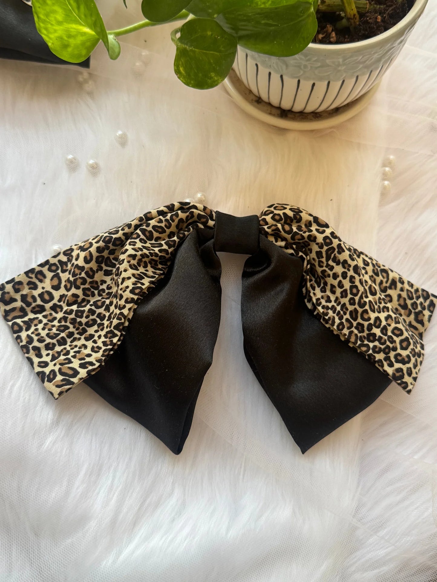 Kate Moss handmade hair bow with leopard print and black satin detail by Bows and Bags India, flat lay styling view