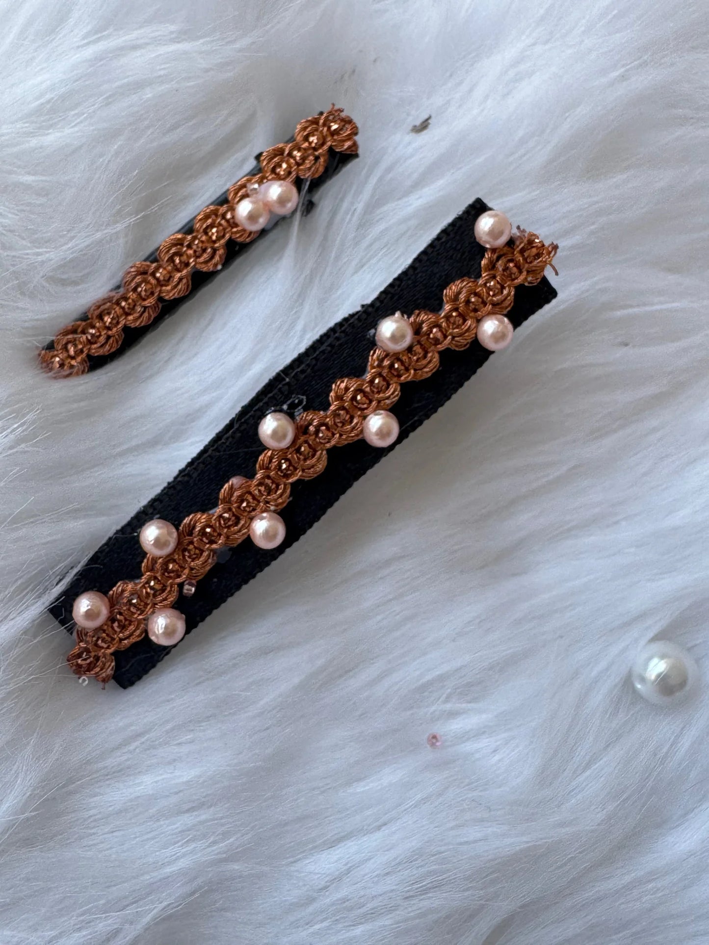 Korean Jazz pearl embroidered hair clips by Bows and Bags India displayed on white fur, showing golden lace detail with