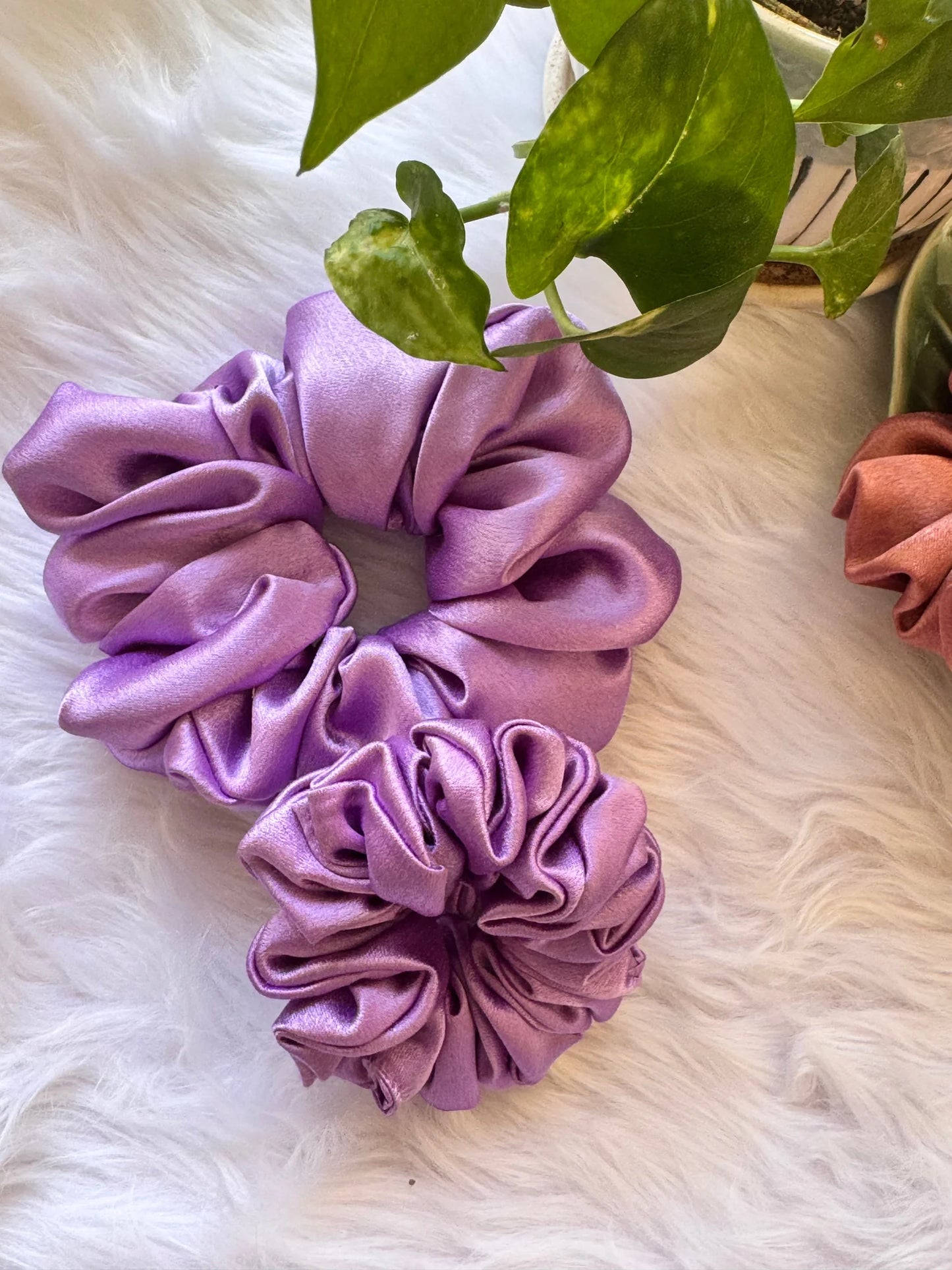 Lavender satin scrunchies duo in large and small sizes displayed on white fur, showing soft fluffy texture and handmade