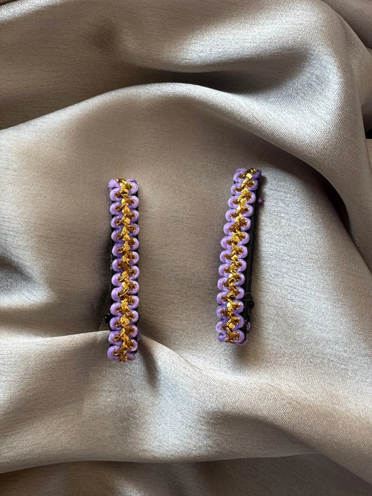Pair of lavender and gold handmade hair clips by Bows and Bags India displayed on neutral fabric, showing intricate beaded