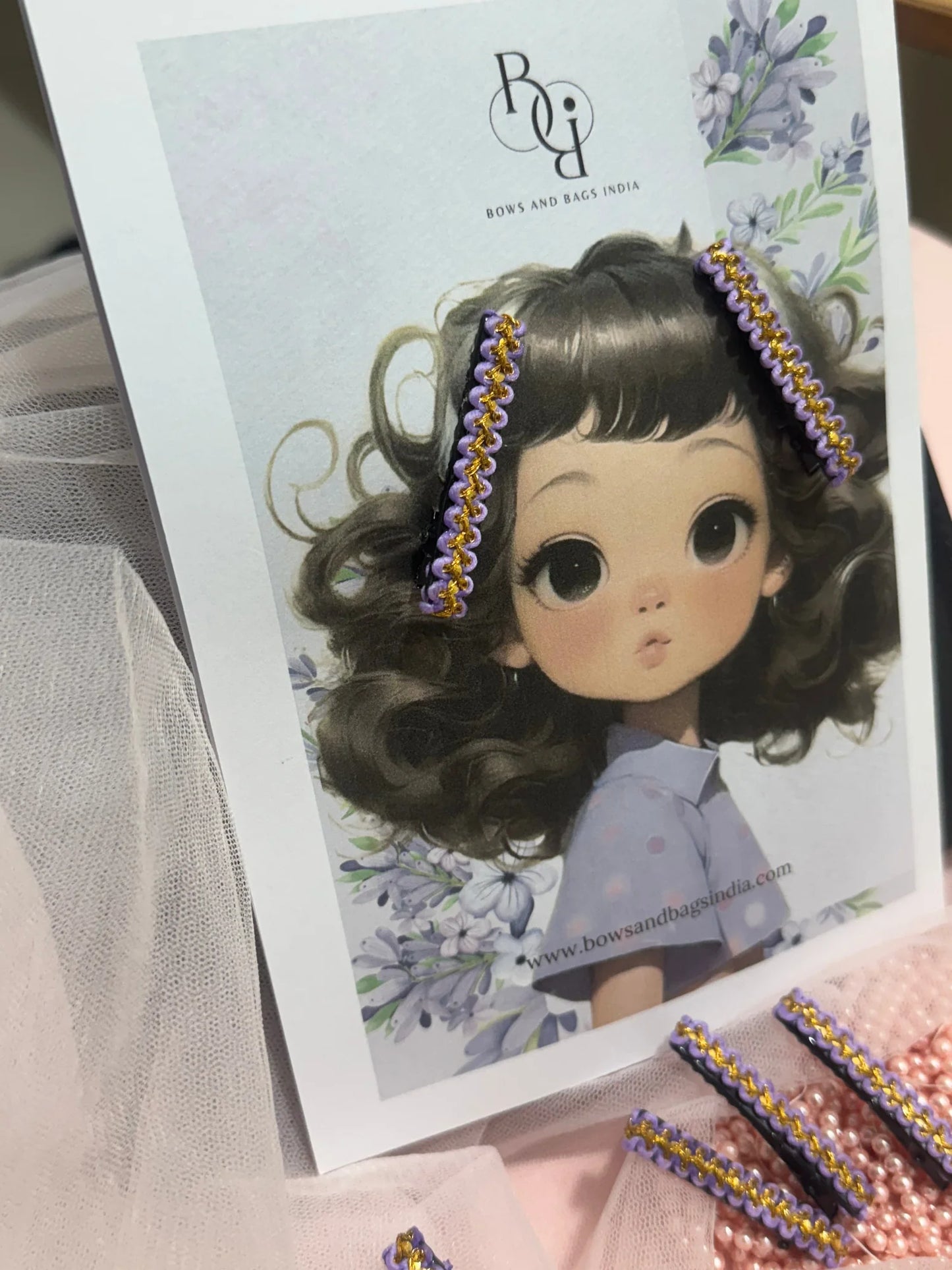 Lavender Paddy hair clip pair with gold beaded trim displayed on doll model, handmade accessory by Bows and Bags India