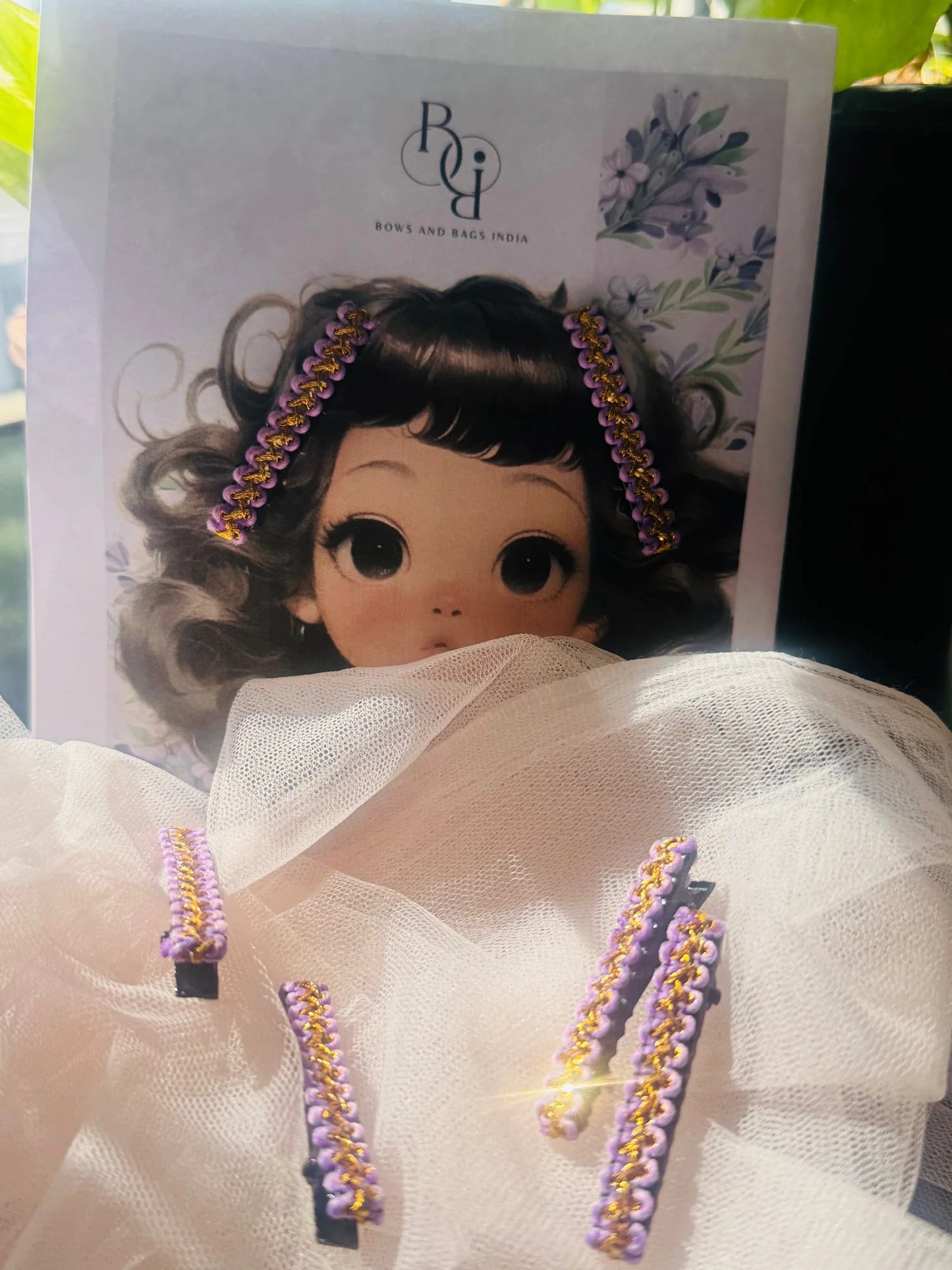 Lavender Paddy hair clip pair with gold beading detail on white mesh packaging by Bows and Bags India