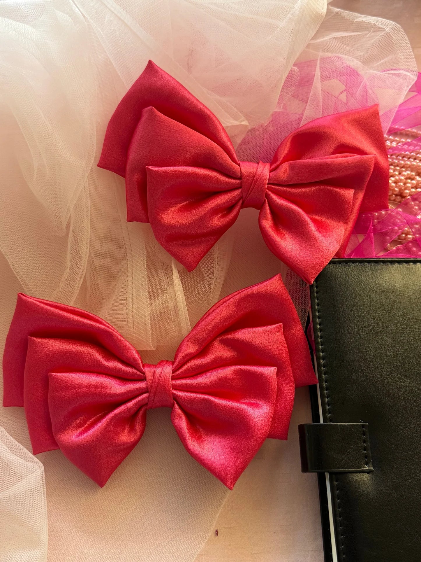 Hot pink satin hair bows by Bows and Bags India displayed with tulle and accessories, showing handmade hair bow details and