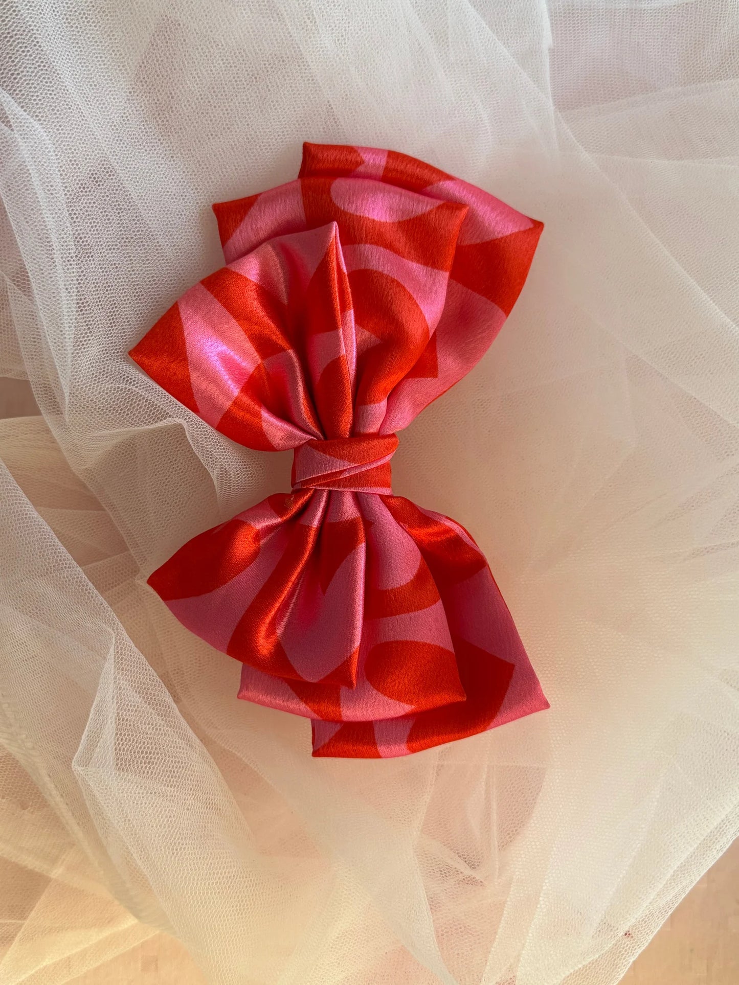Love Struck printed satin hair bow with pink heart design by Bows and Bags India on tulle backdrop