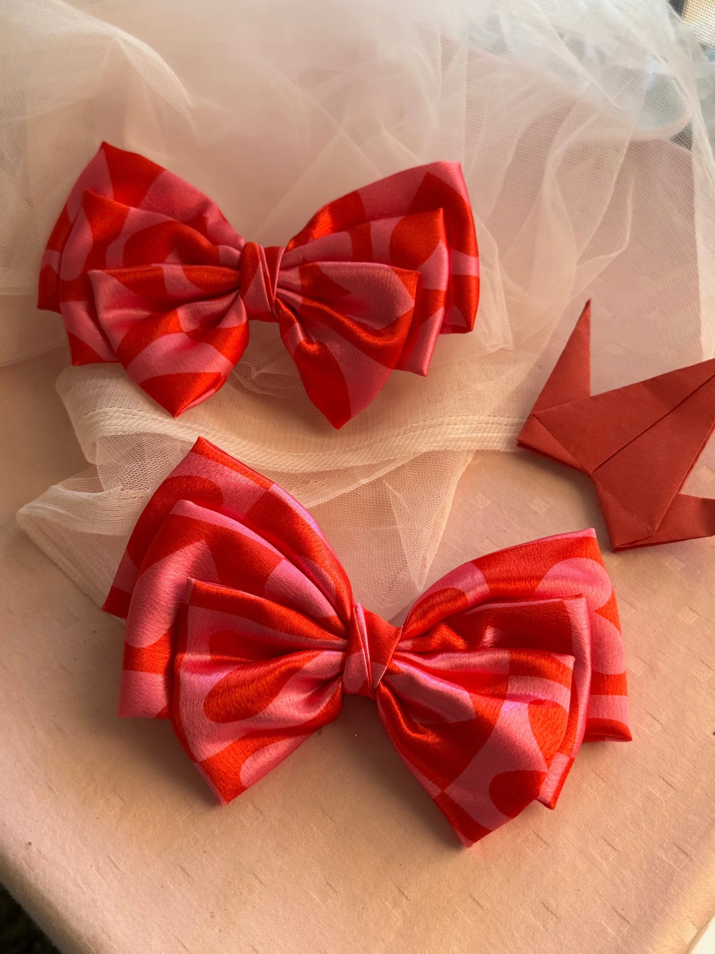 Pink satin hair bows with heart prints by Bows and Bags India, handmade accessories on tulle fabric