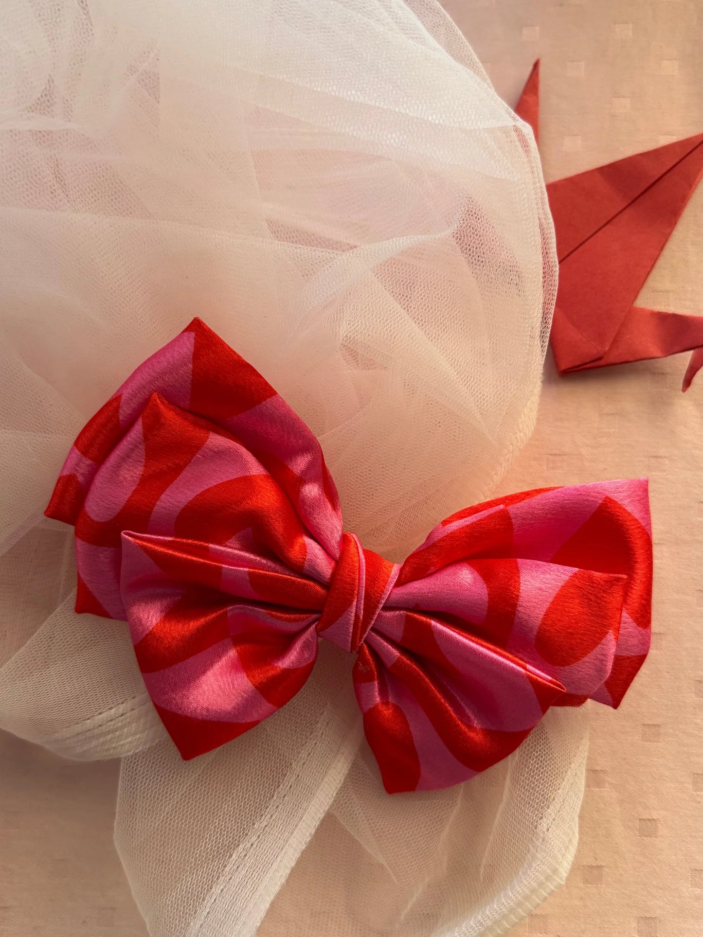 Love Struck printed satin hair bow in pink with heart details by Bows and Bags India, close-up texture view