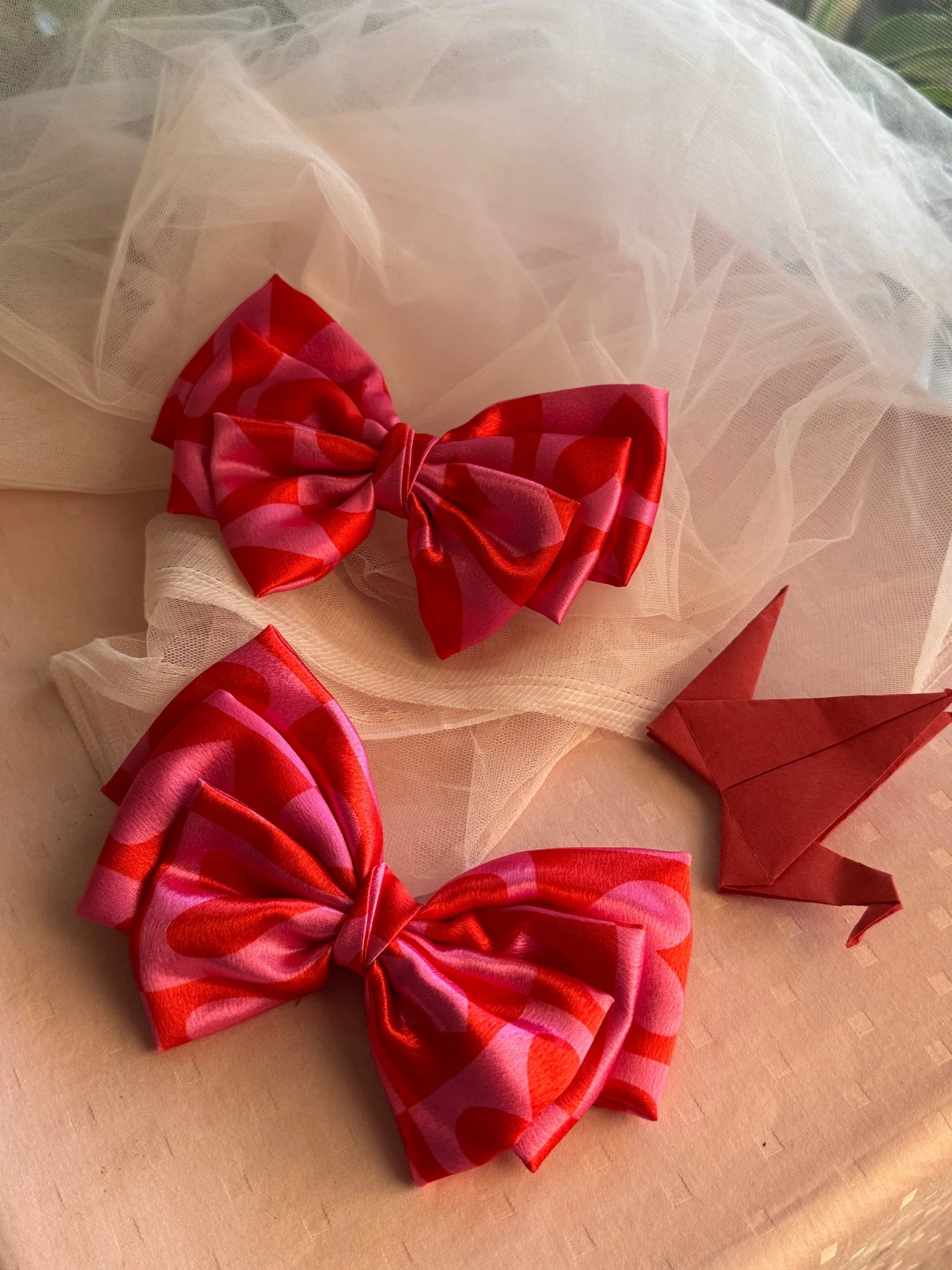 Love Stuck printed satin hair bows with pink heart design by Bows and Bags India, flat lay detail shot