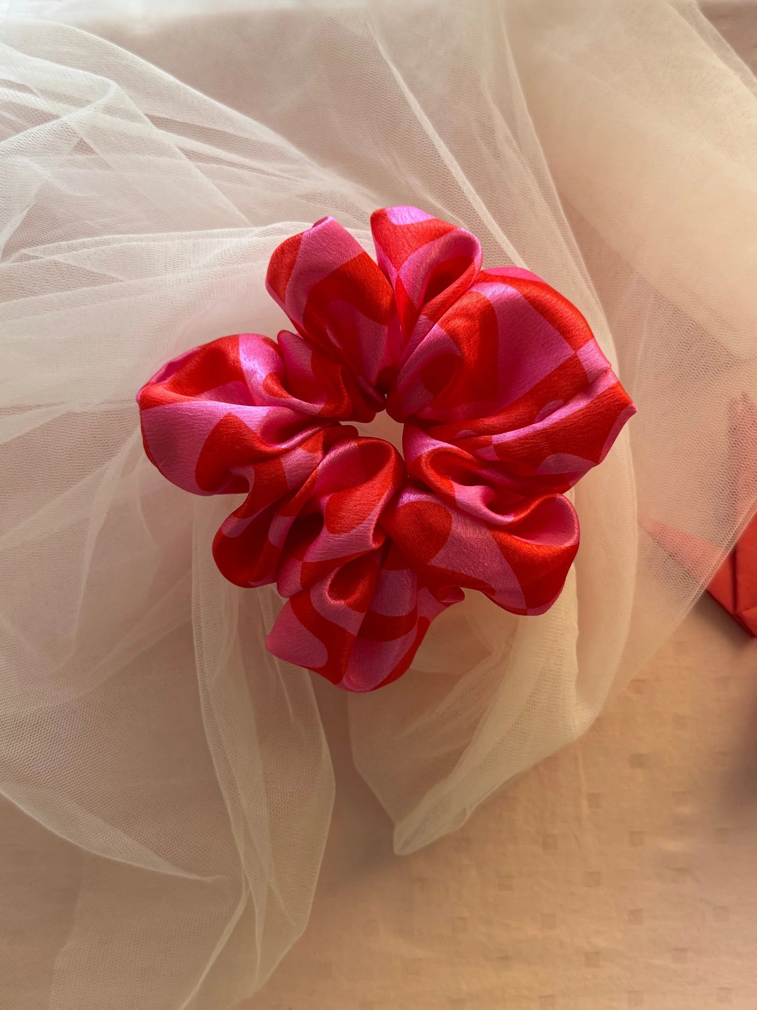 Love Stuck satin scrunchie in pink with heart print, displayed on tulle fabric by Bows and Bags India handmade hair