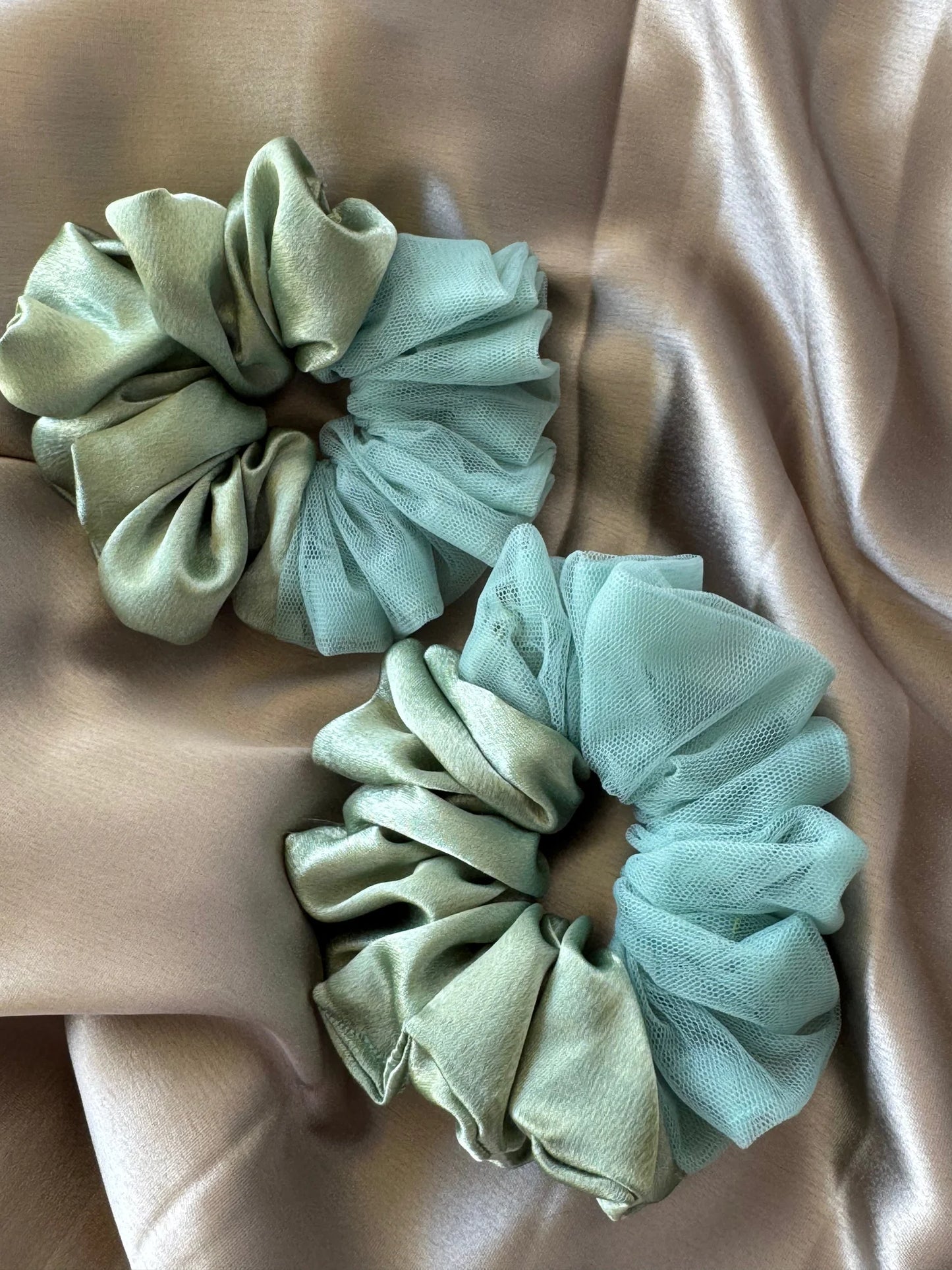 Mint green satin and net scrunchies by Bows and Bags India displayed on neutral fabric, showing handmade hair accessory