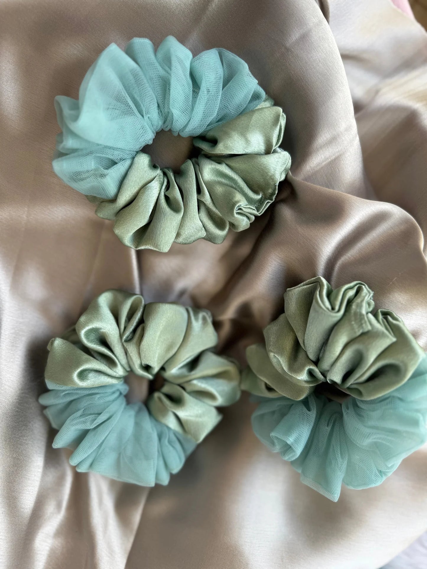 Mint green and cream handmade satin scrunchies with net border detail on silk fabric by Bows and Bags India