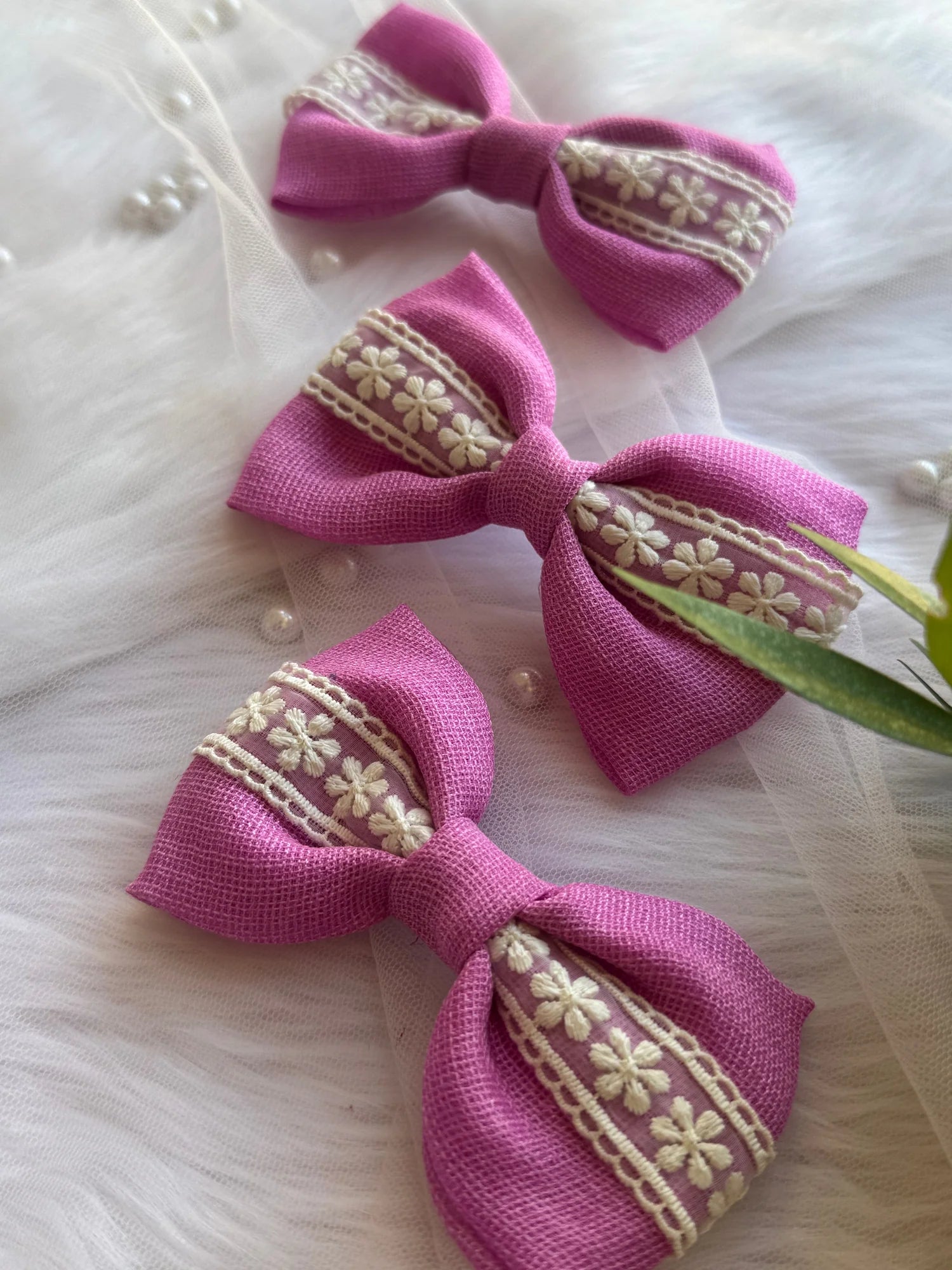 Rose pink cotton handmade hair bows with embroidered floral lace by Bows and Bags India, flat lay styling detail
