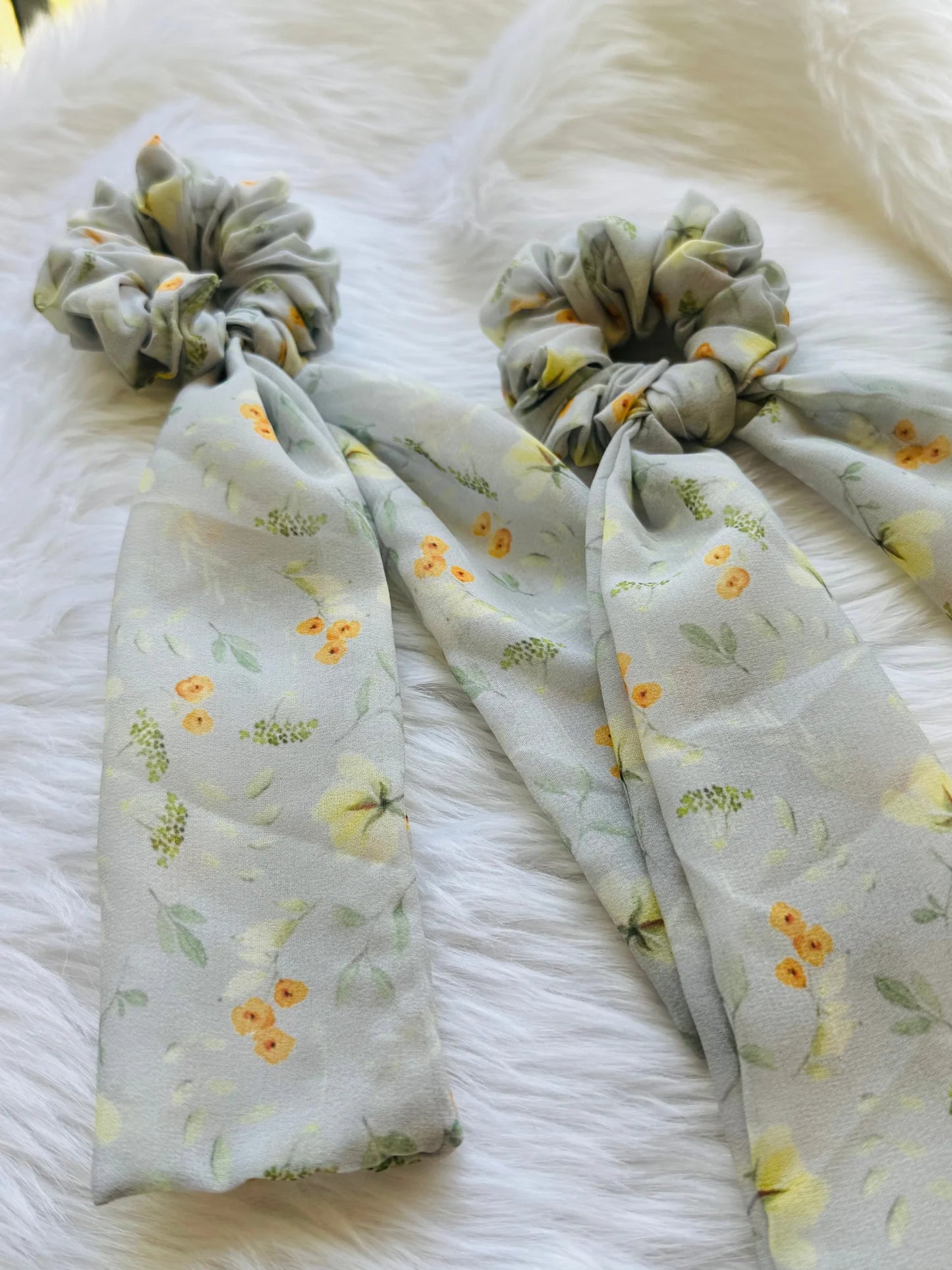 Light green floral georgette tail scrunchie with yellow flowers by Bows and Bags India, showing detailed fabric texture and