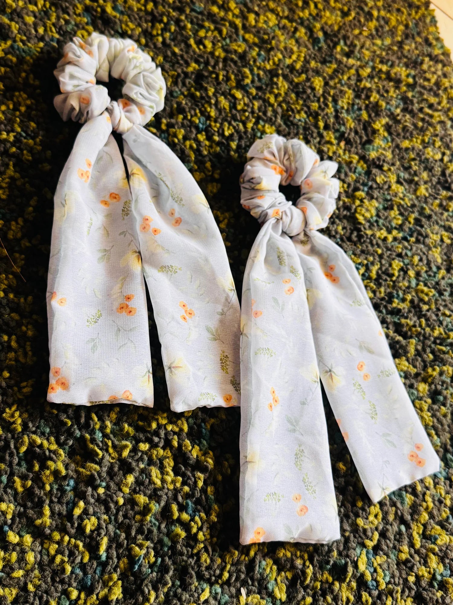Pair of light green floral georgette tail scrunchies with flowing tails by Bows and Bags India, handmade hair accessories