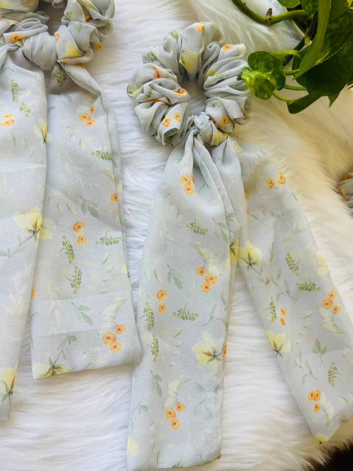 Light green floral georgette tail scrunchie with orange blooms and flowing fabric tails by Bows and Bags India handmade hair