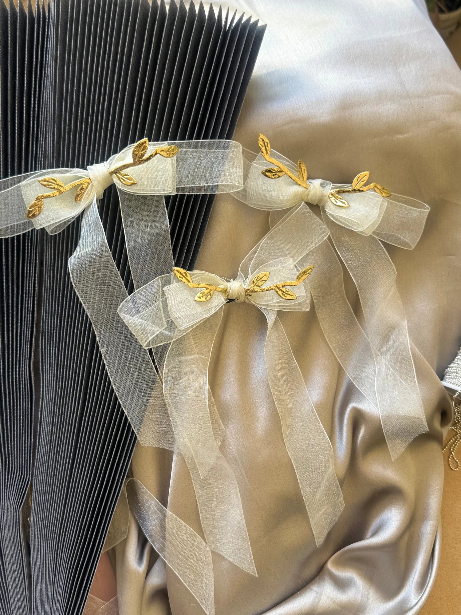 O So Roman white transparent hair bow with gold leaf detailing by Bows and Bags India, handmade hair accessory displayed on