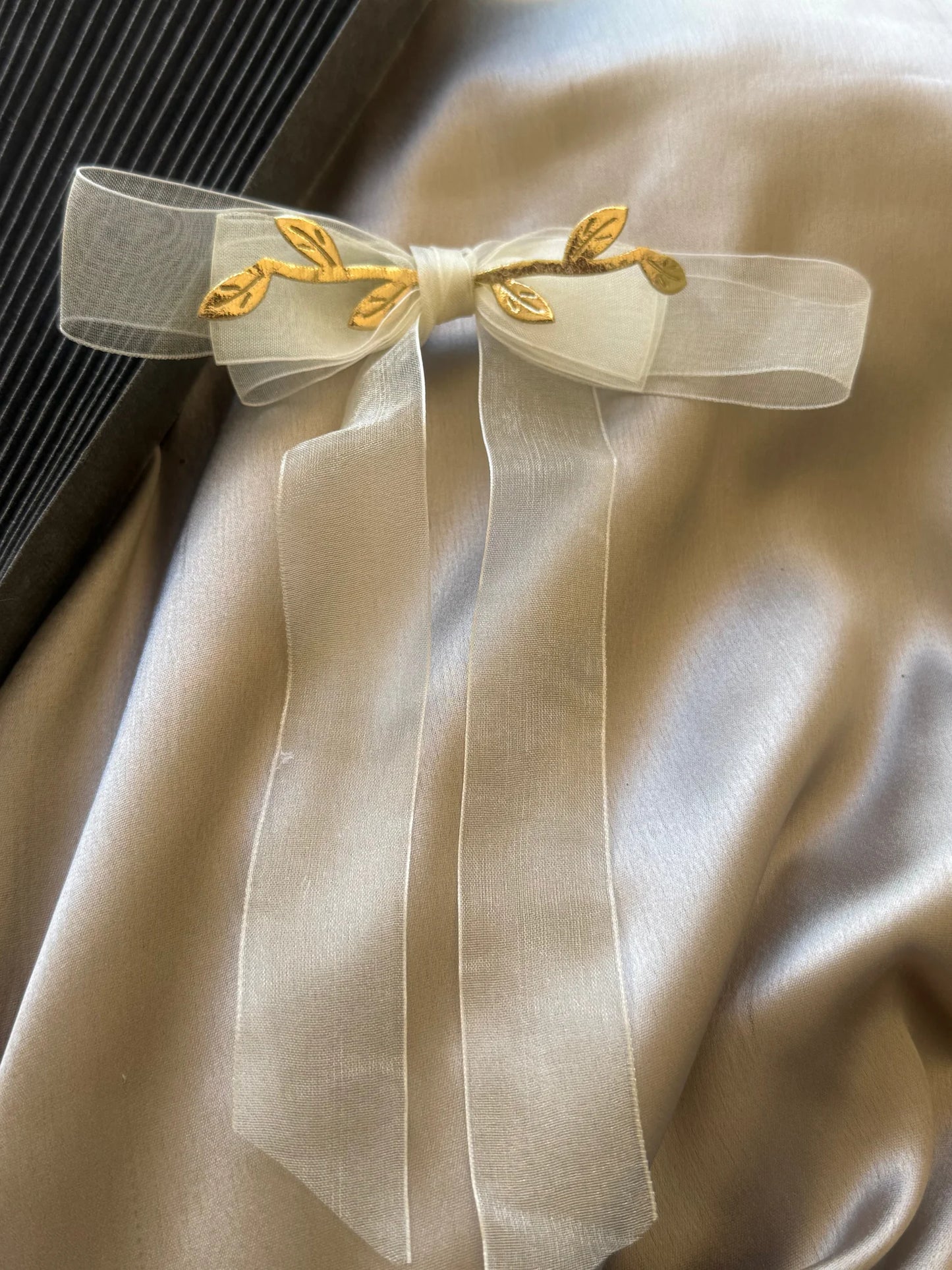 O So Roman handmade hair clip with white transparent bow and gold leaf detailing by Bows and Bags India