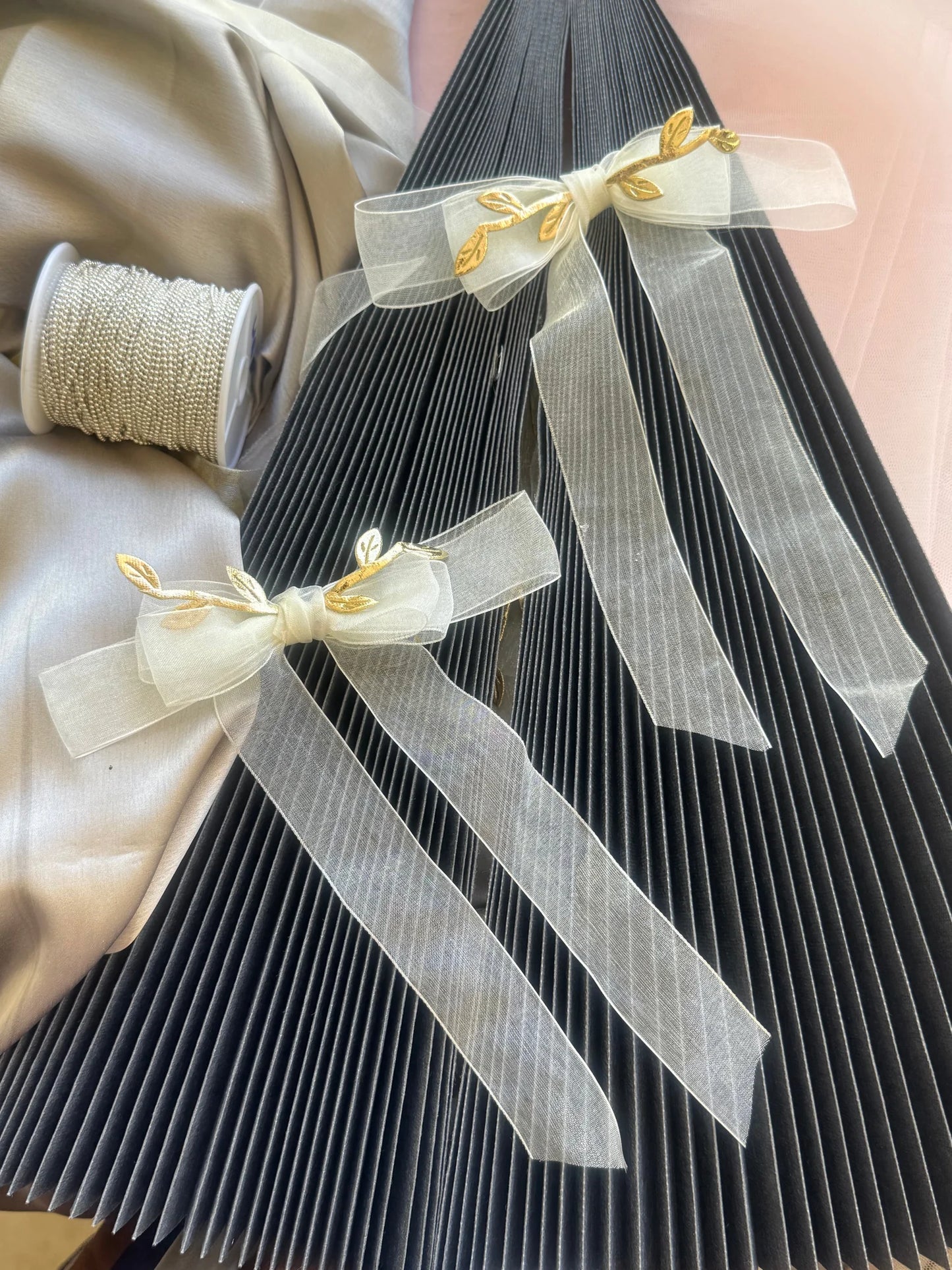 O So Roman white transparent hair bow with gold leaf details by Bows and Bags India, handmade hair accessory displayed on