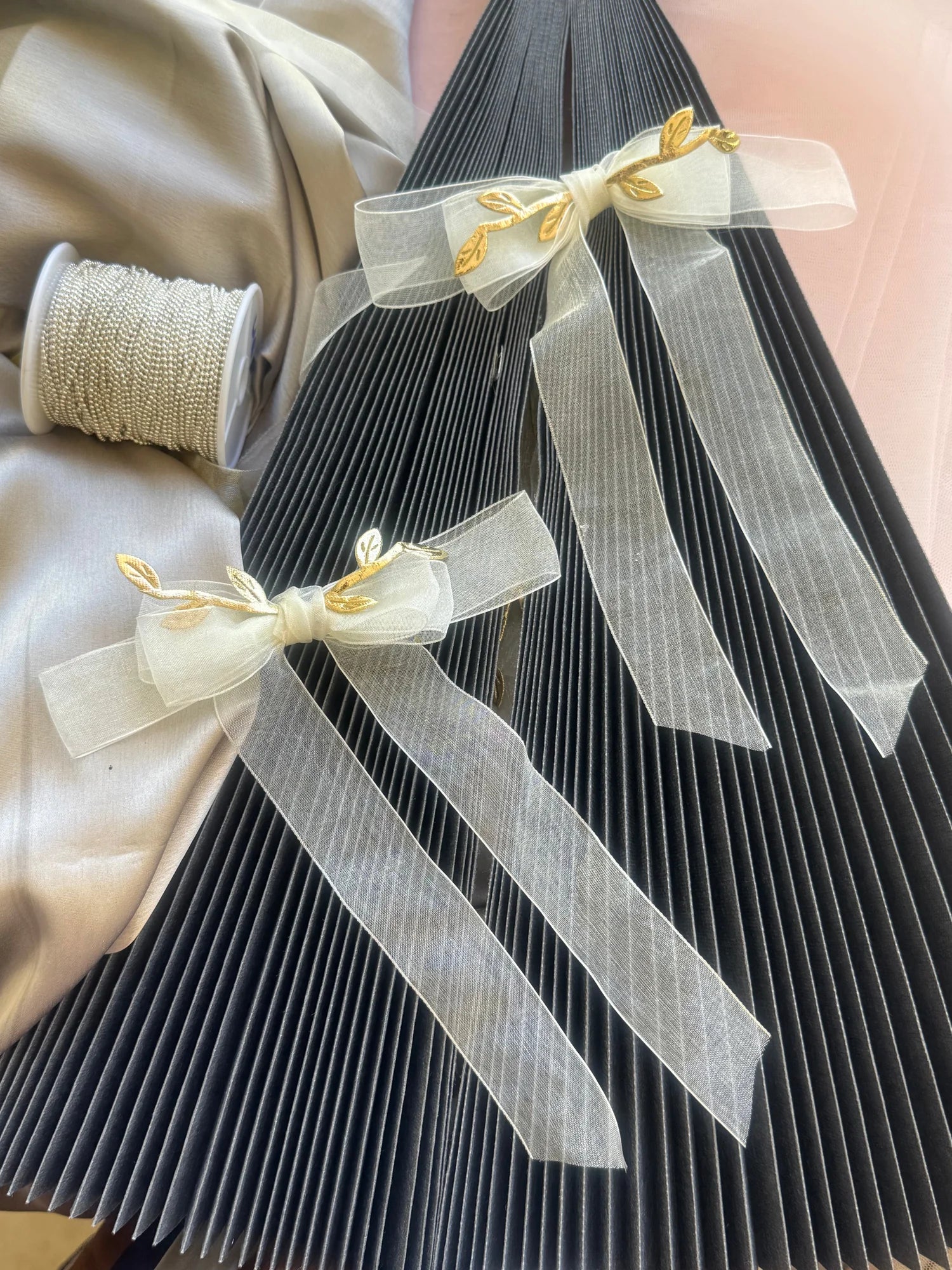 O So Roman white transparent hair bow with gold leaf details by Bows and Bags India, handmade hair accessory displayed on