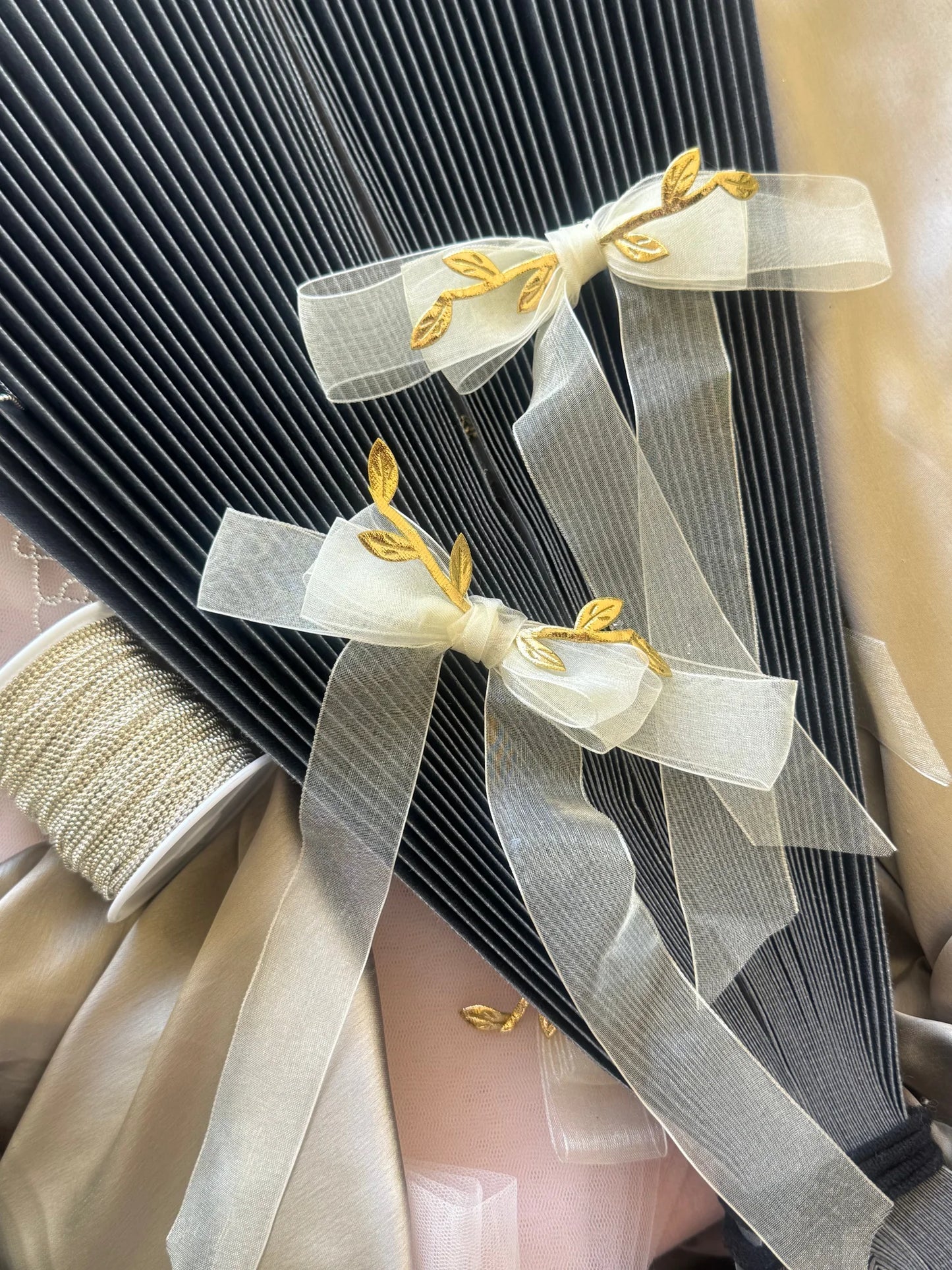 White transparent hair bow with gold leaf details on black striped fabric, Bows and Bags India handmade hair clip accessory