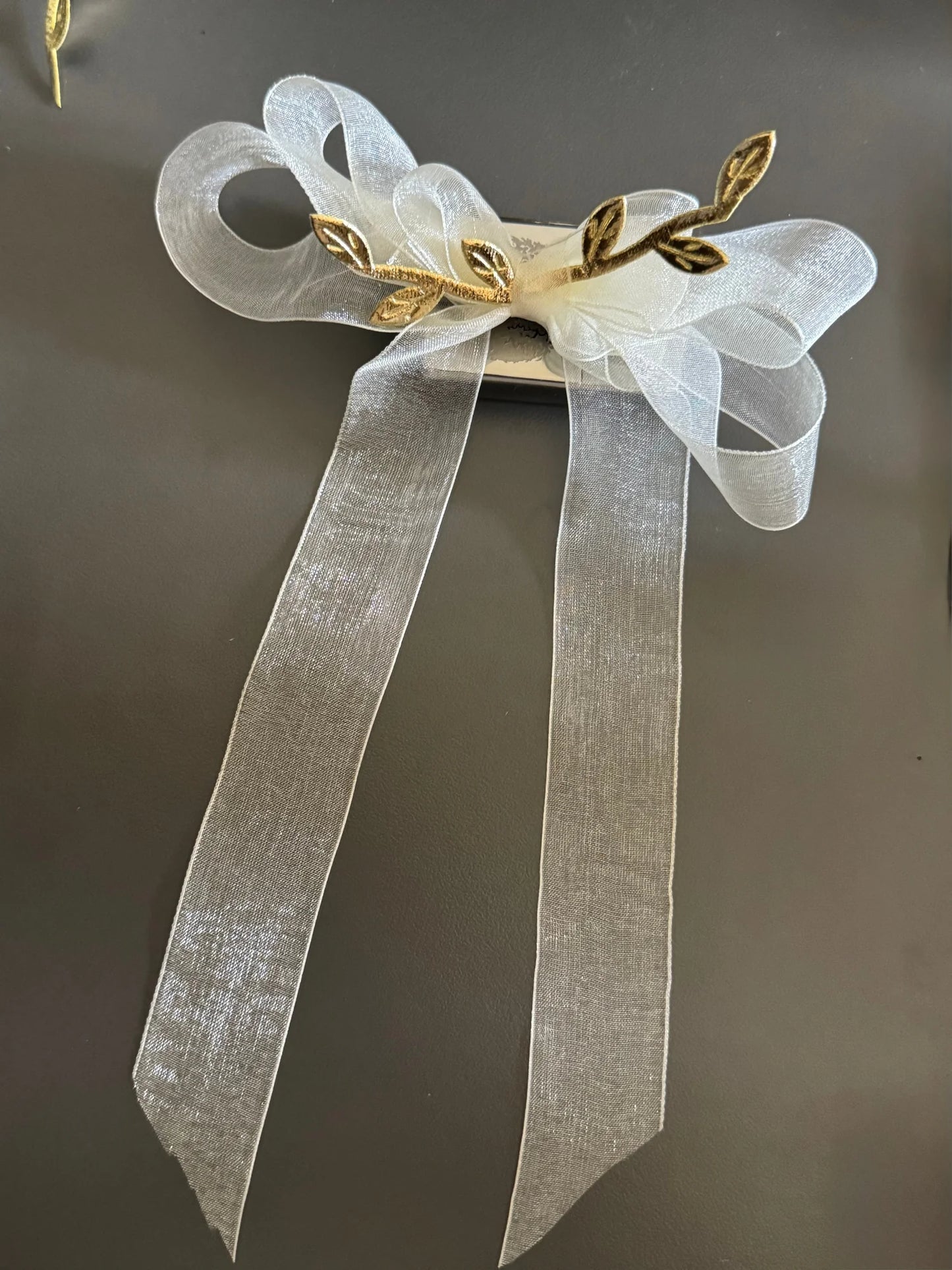 White transparent bow hair clip with gold leaf details by Bows and Bags India, elegant handmade accessory with flowing
