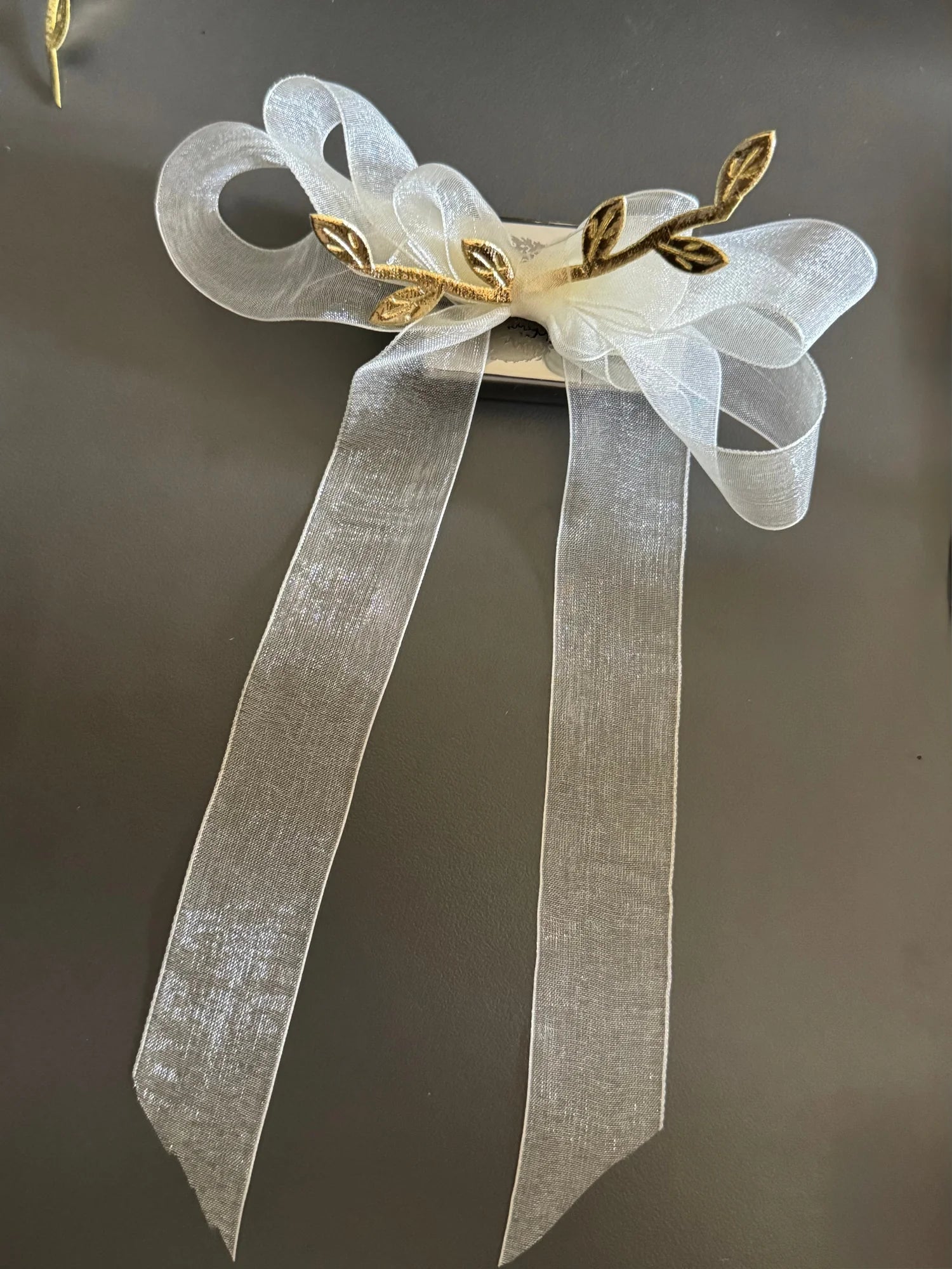 White transparent bow hair clip with gold leaf details by Bows and Bags India, elegant handmade accessory with flowing