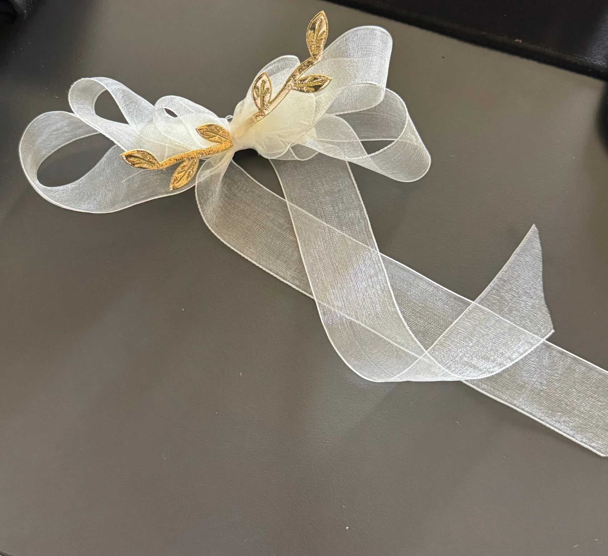 White sheer organza hair bow with gold leaf accents by Bows and Bags India, elegant handmade hair clip detail shot showing
