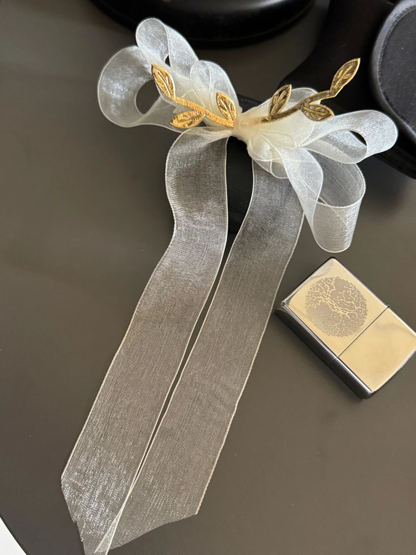 White sheer hair bow clip with gold leaf accents by Bows and Bags India, handmade accessory on neutral background