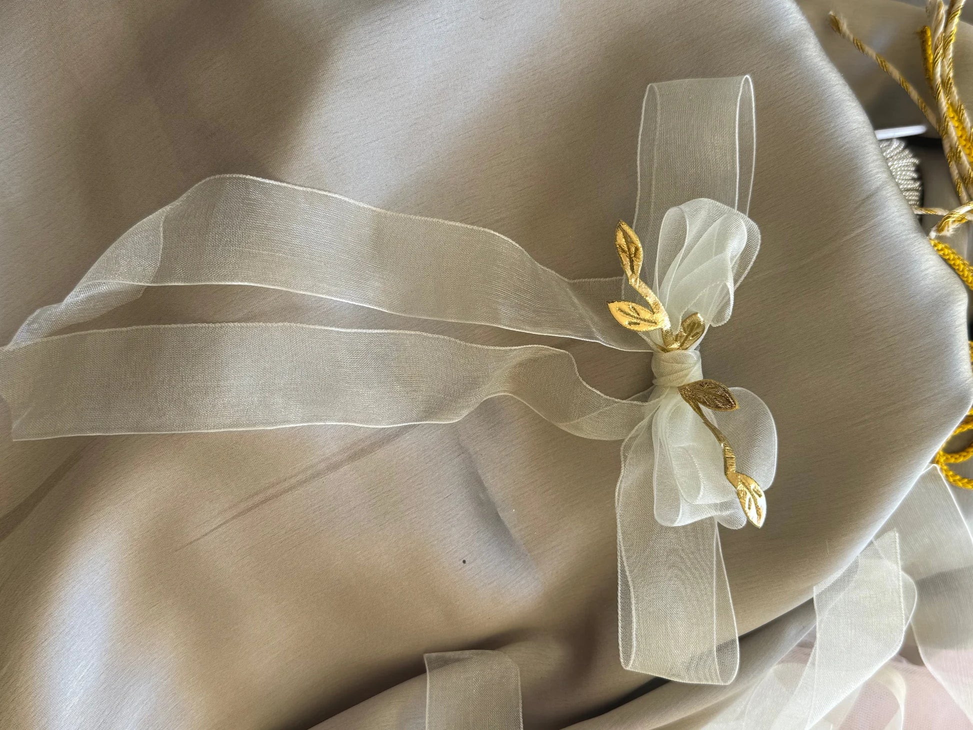 White transparent hair bow with gold leaf details on cream fabric, Bows and Bags India handmade clip accessory