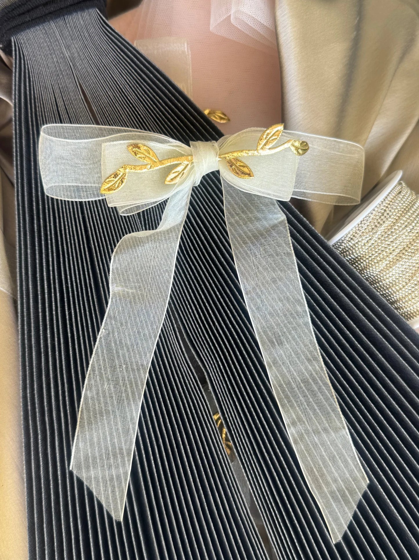 O So Roman white transparent hair bow with gold leaf details by Bows and Bags India, handmade hair accessory displayed on