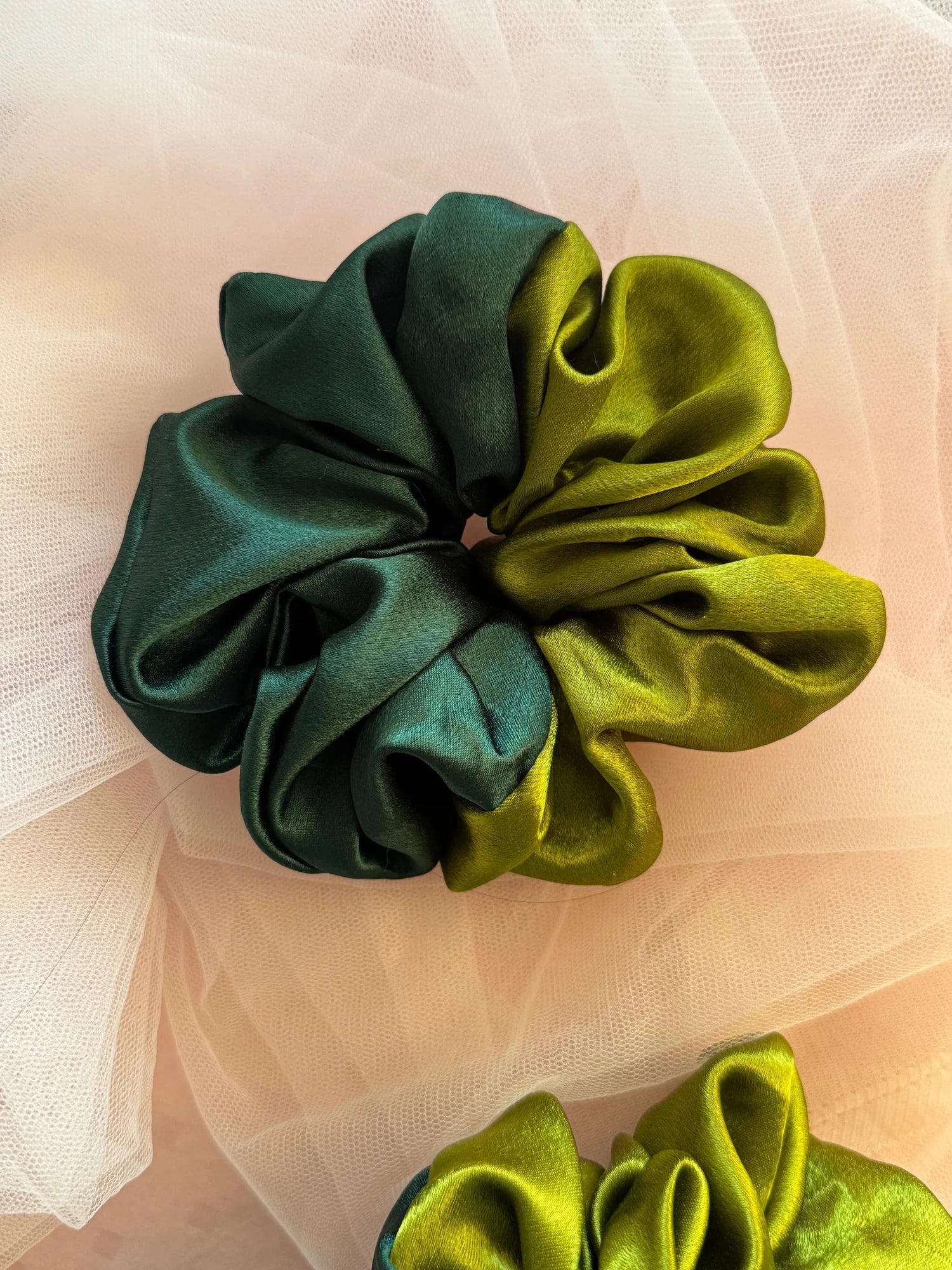 Olive Garden dual-color satin scrunchie in olive and dark green, handmade by Bows and Bags India, displayed on tulle fabric