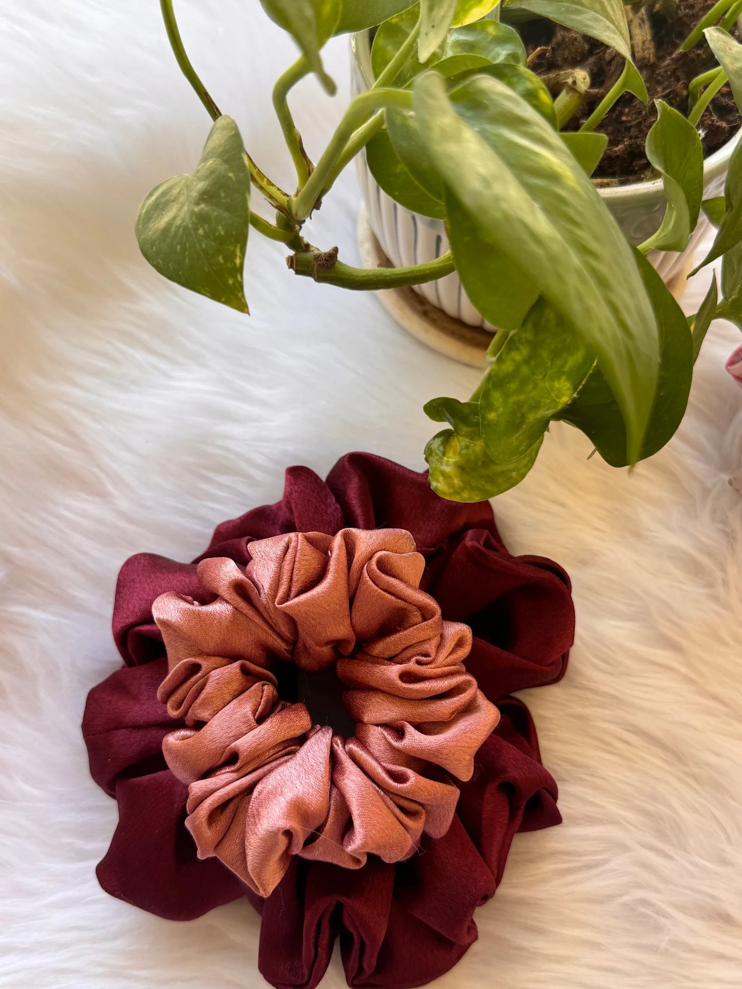 Peachy Fizz satin scrunchies duo in dark fuchsia and peach pink displayed on white fur, showing handmade texture and fluffy