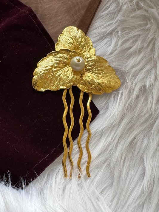Pearl Golden Leaf hair pin by Bows and Bags India with textured gold leaves and lustrous pearl center on neutral fabric