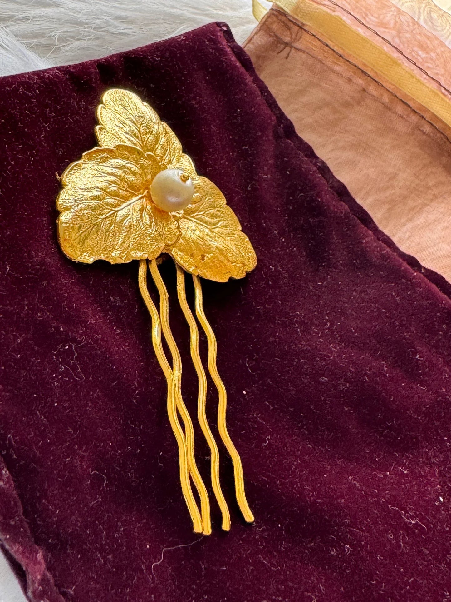 Pearl Golden Leaf hair pin on burgundy velvet by Bows and Bags India, gold textured leaves with pearl detail and wavy prongs