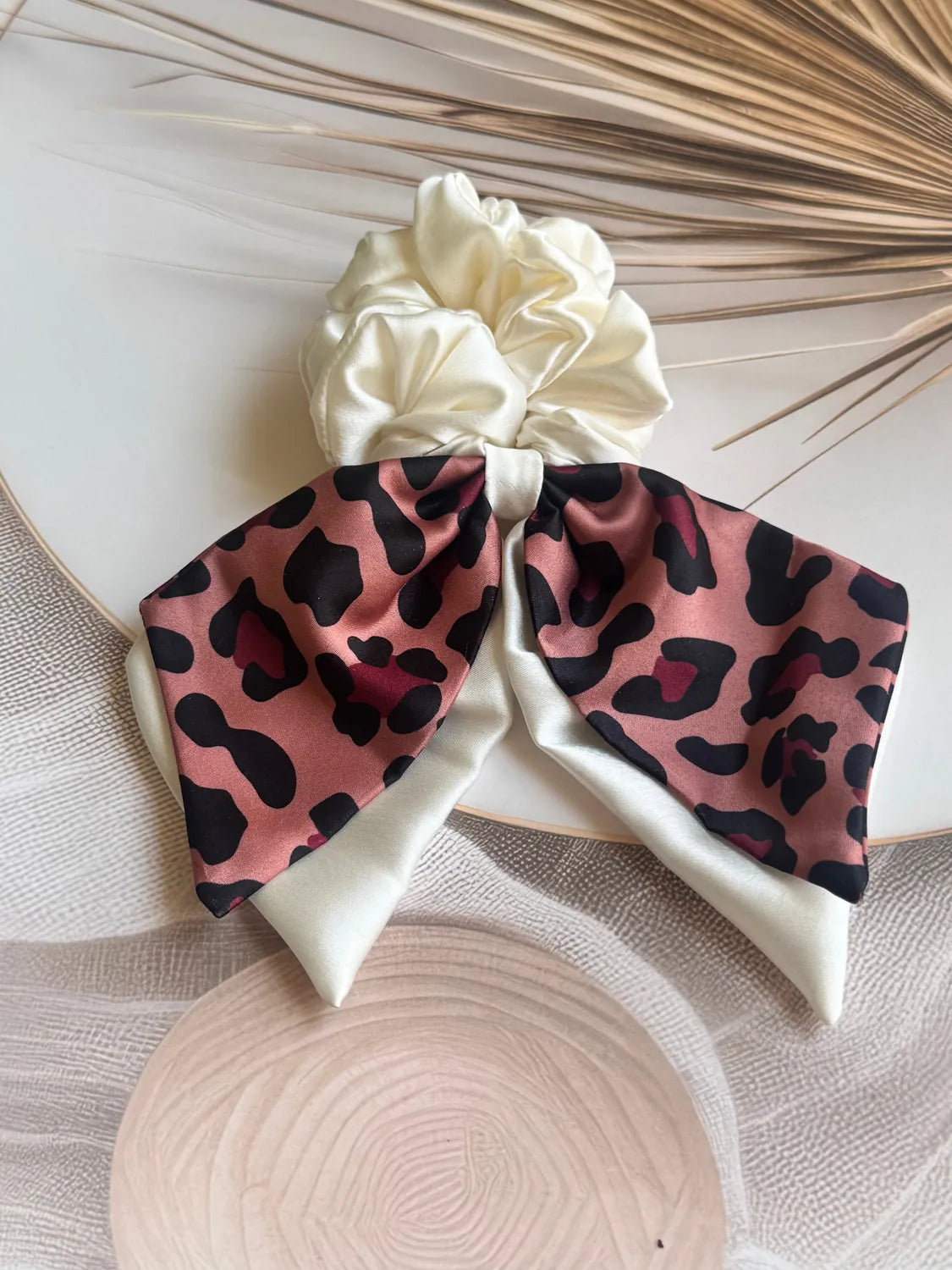 Dusty rose leopard print satin bow scrunchie with dual long tails by Bows and Bags India handmade hair accessory flat lay