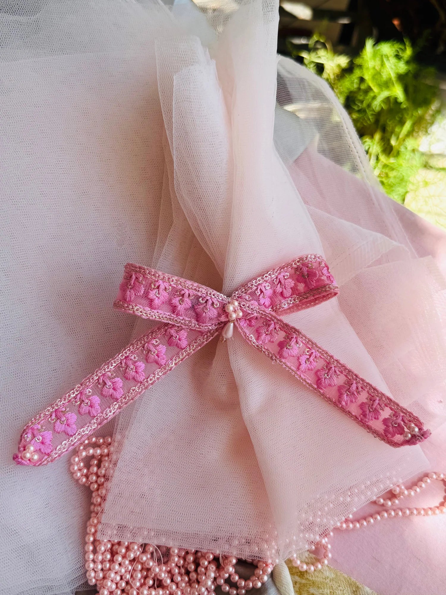 Pink pearl flower hair clip with embroidered floral design and pearl center, handmade accessory by Bows and Bags India
