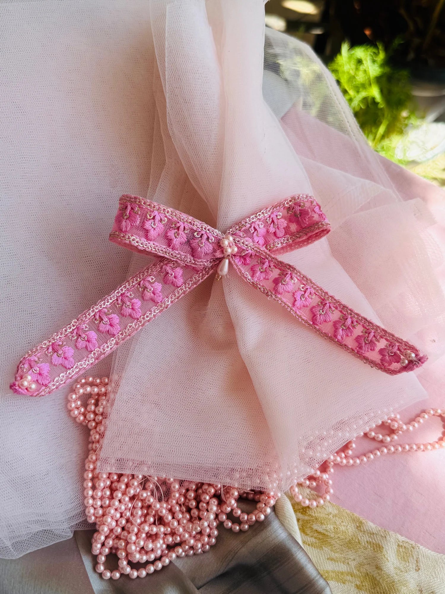 Pink pearl beaded hair clip detail with embroidered floral bow by Bows and Bags India handmade accessories