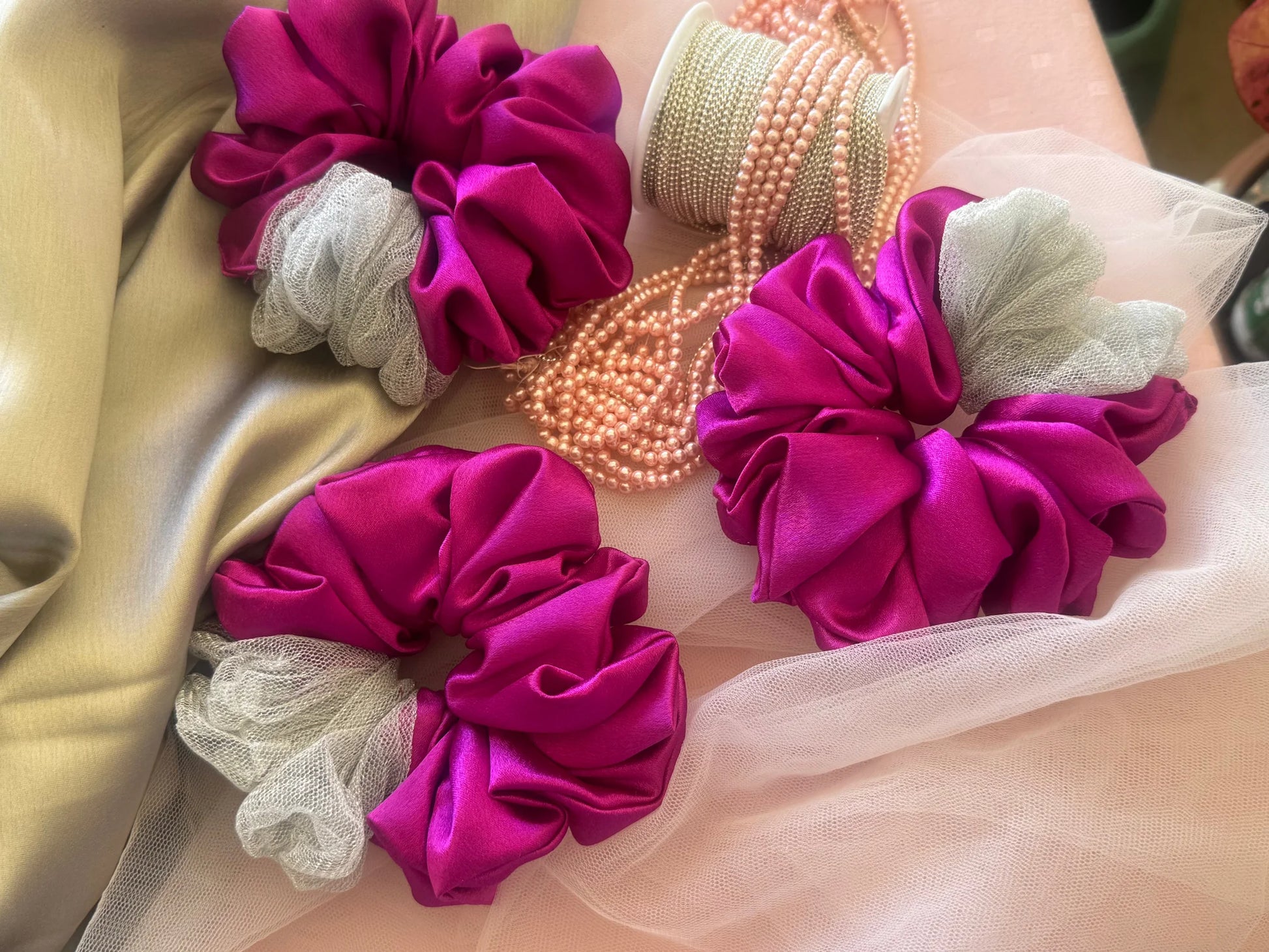 Vibrant pink satin scrunchies with silver net detail and pearl beads by Bows and Bags India, handmade hair accessories